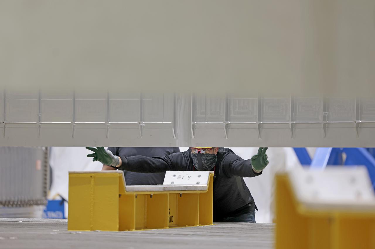 On Thursday, February 10, 2022, move crews at NASA’s Michoud Assembly Facility lift the core stage 3 liquid oxygen tank (LOX) aft barrel out of the vertical friction stir weld tool to be moved for its next phase of production. Eventually, the aft barrel will be mated with the forward barrel and forward and aft domes to create the LOX tank, which will be used for the Space Launch System’s Artemis III mission. The LOX tank holds 196,000 gallons of super-cooled liquid oxygen to help fuel four RS-25 engines. The SLS core stage is made up of five unique elements: the forward skirt, liquid oxygen tank, intertank, liquid hydrogen tank, and the engine section. The liquid oxygen hardware, along with the liquid hydrogen tank will provide propellant to the four RS-25 engines to produce more than two million pounds of thrust to help launch NASA’s Orion spacecraft, astronauts, and supplies beyond Earth’s orbit to the Moon. Image credit: NASA/Michael DeMocker