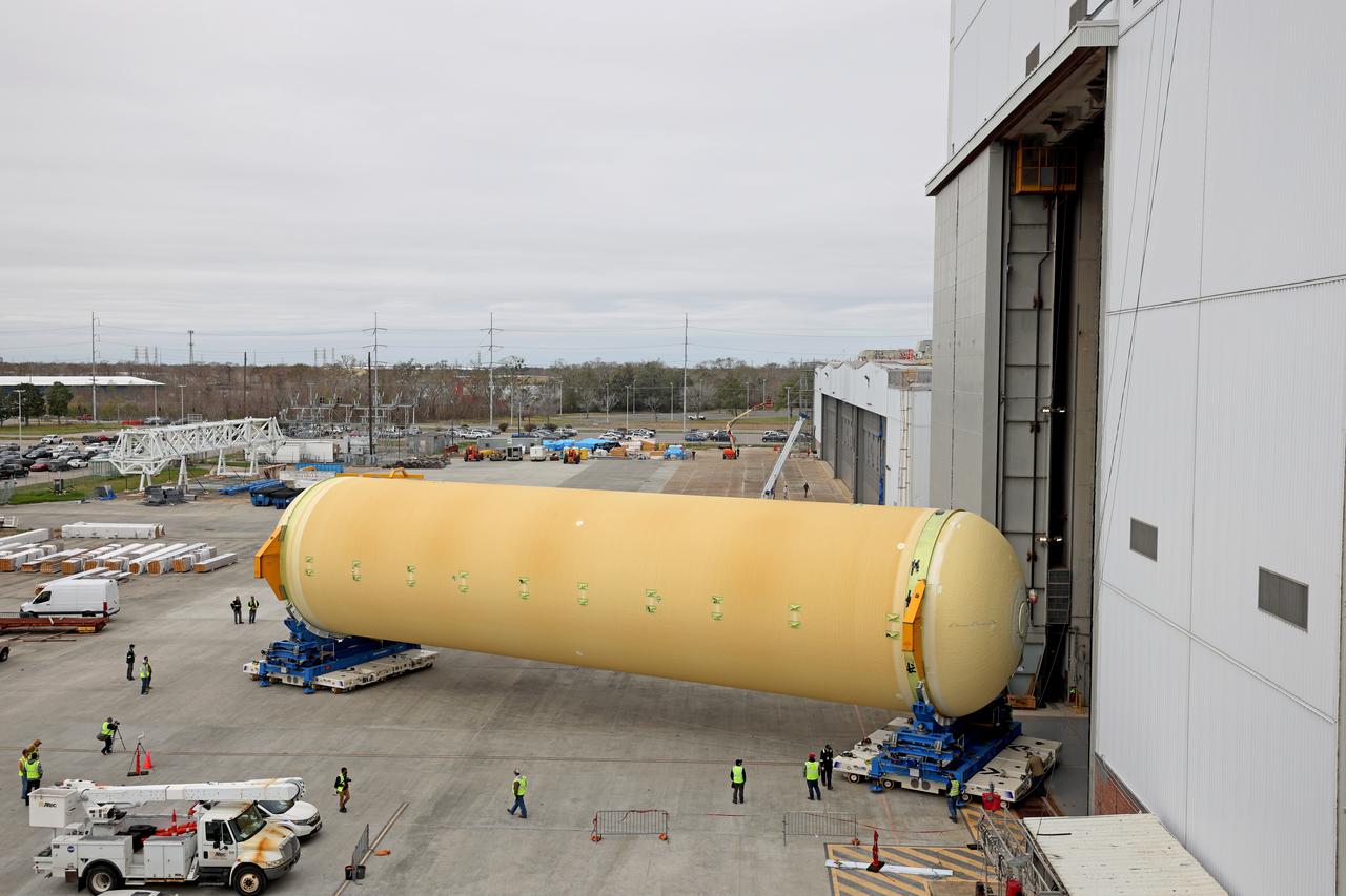 NASA is preparing major pieces of the Space Launch System rocket’s core stage to be joined as part of assembling the core stage for the Artemis II mission that will send crews to lunar orbit. Crews will soon connect the forward assembly with the 130-foot liquid hydrogen tank in the final assembly area at NASA’s Michoud Assembly Facility in New Orleans. When this process is completed, four of the five large structures that make up the core stage will be joined. The 66-foot forward assembly consists of the forward skirt, liquid oxygen tank and the intertank, which were mated earlier. This forward assembly will be joined with the 130-foot liquid hydrogen tank, the largest part of the stage that holds more than 500,000 gallons of cryogenic propellant. To compete the Artemis II core stage, engineers will add the engine section, which is currently being outfitted and includes the main propulsion systems that connect to the four RS-25 engines, Together, with the SLS twin solid rocket boosters, the core stage will produce 8.8 million pounds of thrust to send NASA’s Orion spacecraft, astronauts, and supplies beyond Earth’s orbit to the Moon. The SLS rocket and the Orion spacecraft form the foundation for deep space exploration and the Artemis lunar program.  For more on the core stage: https://www.nasa.gov/exploration/systems/sls/multimedia/infographics/corestage101.html Image credit: NASA/Michael DeMocker
