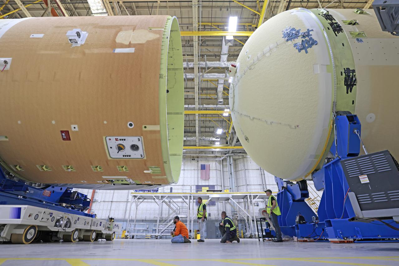 NASA is preparing major pieces of the Space Launch System rocket’s core stage to be joined as part of assembling the core stage for the Artemis II mission that will send crews to lunar orbit. Crews will soon connect the forward assembly with the 130-foot liquid hydrogen tank in the final assembly area at NASA’s Michoud Assembly Facility in New Orleans. When this process is completed, four of the five large structures that make up the core stage will be joined. The 66-foot forward assembly consists of the forward skirt, liquid oxygen tank and the intertank, which were mated earlier. This forward assembly will be joined with the 130-foot liquid hydrogen tank, the largest part of the stage that holds more than 500,000 gallons of cryogenic propellant. To compete the Artemis II core stage, engineers will add the engine section, which is currently being outfitted and includes the main propulsion systems that connect to the four RS-25 engines, Together, with the SLS twin solid rocket boosters, the core stage will produce 8.8 million pounds of thrust to send NASA’s Orion spacecraft, astronauts, and supplies beyond Earth’s orbit to the Moon. The SLS rocket and the Orion spacecraft form the foundation for deep space exploration and the Artemis lunar program.  For more on the core stage: https://www.nasa.gov/exploration/systems/sls/multimedia/infographics/corestage101.html Image credit: NASA/Michael DeMocker