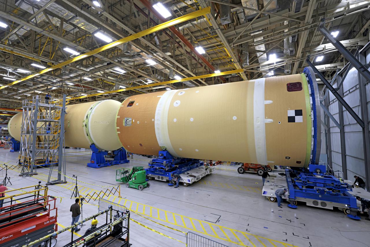 NASA joined the Space Launch System rocket’s core stage forward assembly with the 130-foot liquid hydrogen tank for the Artemis II mission on March 18. This completes assembly of four of the five large structures that make up the core stage that will help send the first astronauts to lunar orbit on Artemis II. The 66-foot forward assembly consists of the forward skirt, liquid oxygen tank and the intertank, which were mated earlier. Engineers inserted 360 bolts to connect the forward assembly to the liquid hydrogen tank to make up the bulk of the stage. Only the engine section, which is currently being outfitted and includes the main propulsion systems that connect to the four RS-25 engines, remains to be added to form the final core stage. All parts of the core stage are manufactured by NASA and Boeing, the core stage lead contractor at the agency’s Michoud Assembly Facility in New Orleans. Currently, the team is building core stages for three Artemis missions. The first core stage is stacked with the rest of the SLS rocket, which will launch the Artemis I mission to the Moon this year. Together with its twin solid rocket boosters, the core stage will produce 8.8 million pounds of thrust to send NASA’s Orion spacecraft, astronauts, and supplies beyond Earth’s orbit to the Moon. The SLS rocket and the Orion spacecraft form the foundation for Artemis missions and future deep space exploration. Image credit: NASA/Michael DeMocker