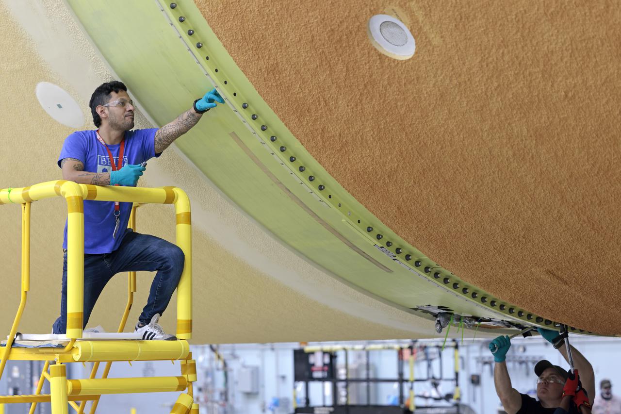 NASA joined the Space Launch System rocket’s core stage forward assembly with the 130-foot liquid hydrogen tank for the Artemis II mission on March 18. This completes assembly of four of the five large structures that make up the core stage that will help send the first astronauts to lunar orbit on Artemis II. The 66-foot forward assembly consists of the forward skirt, liquid oxygen tank and the intertank, which were mated earlier. Engineers inserted 360 bolts to connect the forward assembly to the liquid hydrogen tank to make up the bulk of the stage. Only the engine section, which is currently being outfitted and includes the main propulsion systems that connect to the four RS-25 engines, remains to be added to form the final core stage. All parts of the core stage are manufactured by NASA and Boeing, the core stage lead contractor at the agency’s Michoud Assembly Facility in New Orleans. Currently, the team is building core stages for three Artemis missions. The first core stage is stacked with the rest of the SLS rocket, which will launch the Artemis I mission to the Moon this year. Together with its twin solid rocket boosters, the core stage will produce 8.8 million pounds of thrust to send NASA’s Orion spacecraft, astronauts, and supplies beyond Earth’s orbit to the Moon. The SLS rocket and the Orion spacecraft form the foundation for Artemis missions and future deep space exploration. Image credit: NASA/Michael DeMocker