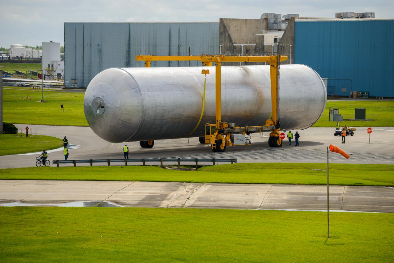 The core stage liquid hydrogen tank for the Artemis III mission completed proof testing, and technicians returned it to the main factory building at NASA’s Michoud Assembly Facility in New Orleans where it will undergo more outfitting. As part of proof testing, technicians apply a simple soap solution and check for leaks by observing any bubble formation on the welds. The technician removed the bubble solution with distilled water and then dried the area of application to prevent corrosion. To build the Space Launch System (SLS) rocket’s 130-foot core stage liquid hydrogen tank, engineers use robotic tools to weld five-barrel segments. This process results in a tank with around 1,900 feet, or more than six football fields, of welds that must be tested by hand. After the leak tests, the core stage lead, Boeing, pressurized the SLS tank to further ensure there were no leaks. After it passed proof testing, technicians moved the Artemis III liquid hydrogen tank to Michoud’s main factory. Soon, the technicians will prime and apply a foam-based thermal protection system that protects the tank during launch. Later, the tank will be joined with other parts of the core stage to form the entire 212-foot rocket stage with its four RS-25 engines that produce 2 million pounds of thrust to help launch the rocket. Artemis III will land the first astronauts on the lunar surface. Photographed on Monday, April 18, 2022. 