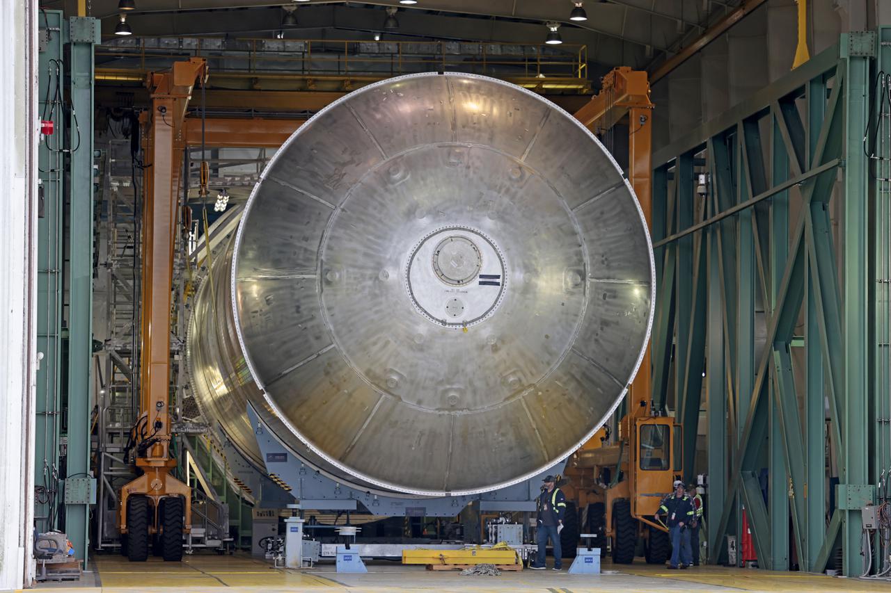 The core stage liquid hydrogen tank for the Artemis III mission completed proof testing, and technicians returned it to the main factory building at NASA’s Michoud Assembly Facility in New Orleans where it will undergo more outfitting. As part of proof testing, technicians apply a simple soap solution and check for leaks by observing any bubble formation on the welds. The technician removed the bubble solution with distilled water and then dried the area of application to prevent corrosion. To build the Space Launch System (SLS) rocket’s 130-foot core stage liquid hydrogen tank, engineers use robotic tools to weld five-barrel segments. This process results in a tank with around 1,900 feet, or more than six football fields, of welds that must be tested by hand.  After the leak tests, the core stage lead, Boeing, pressurized the SLS tank to further ensure there were no leaks.  After it passed proof testing, technicians moved the Artemis III liquid hydrogen tank to Michoud’s main factory. Soon, the technicians will prime and apply a foam-based thermal protection system that protects the tank during launch. Later, the tank will be joined with other parts of the core stage to form the entire 212-foot rocket stage with its four RS-25 engines that produce 2 million pounds of thrust to help launch the rocket. Artemis III will land the first astronauts on the lunar surface. Photographed on Monday, April 18, 2022. Image credit: NASA/Michael DeMocker