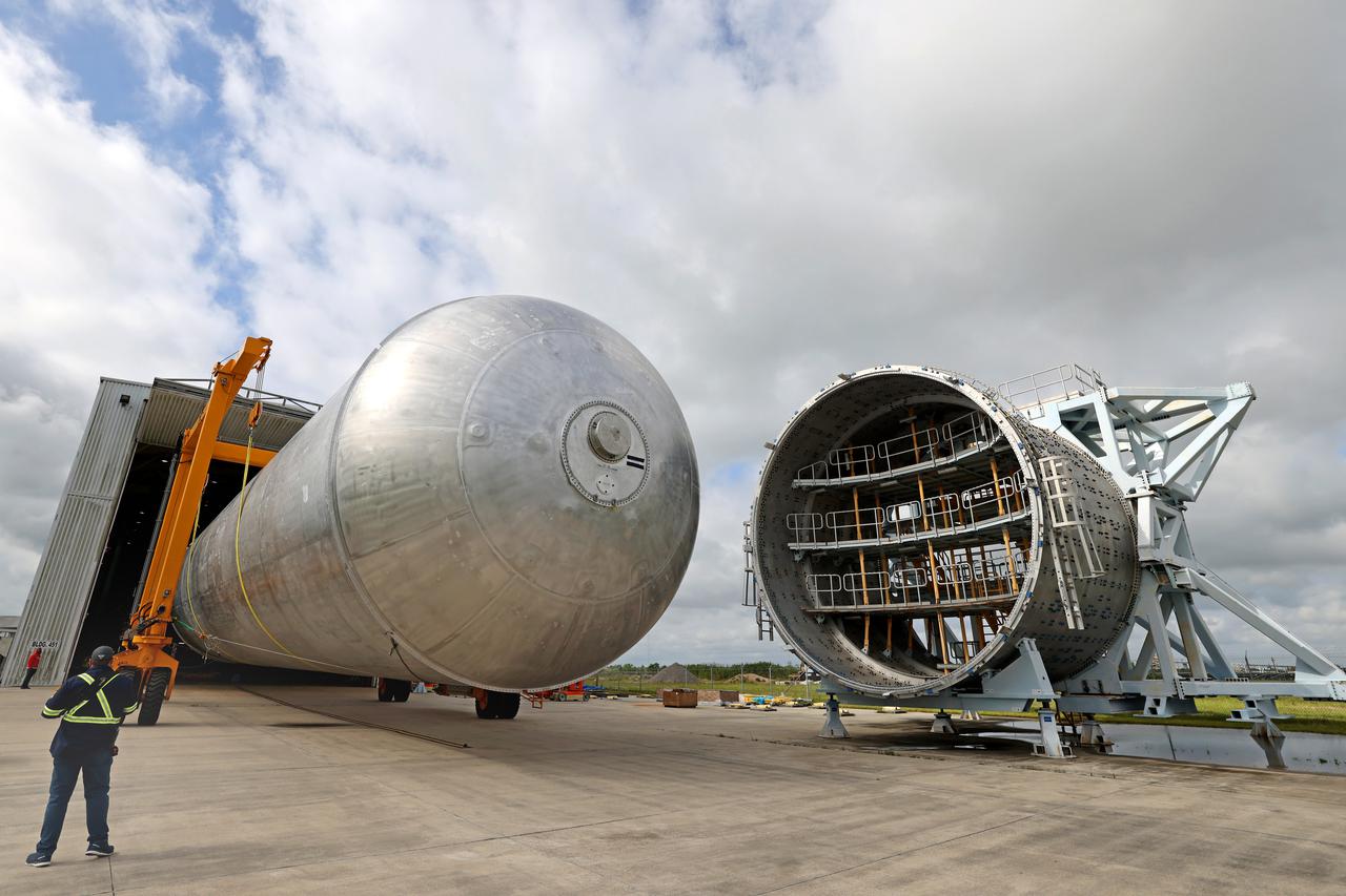 The core stage liquid hydrogen tank for the Artemis III mission completed proof testing, and technicians returned it to the main factory building at NASA’s Michoud Assembly Facility in New Orleans where it will undergo more outfitting. As part of proof testing, technicians apply a simple soap solution and check for leaks by observing any bubble formation on the welds. The technician removed the bubble solution with distilled water and then dried the area of application to prevent corrosion. To build the Space Launch System (SLS) rocket’s 130-foot core stage liquid hydrogen tank, engineers use robotic tools to weld five-barrel segments. This process results in a tank with around 1,900 feet, or more than six football fields, of welds that must be tested by hand.  After the leak tests, the core stage lead, Boeing, pressurized the SLS tank to further ensure there were no leaks.  After it passed proof testing, technicians moved the Artemis III liquid hydrogen tank to Michoud’s main factory. Soon, the technicians will prime and apply a foam-based thermal protection system that protects the tank during launch. Later, the tank will be joined with other parts of the core stage to form the entire 212-foot rocket stage with its four RS-25 engines that produce 2 million pounds of thrust to help launch the rocket. Artemis III will land the first astronauts on the lunar surface. Photographed on Monday, April 18, 2022. Image credit: NASA/Michael DeMocker