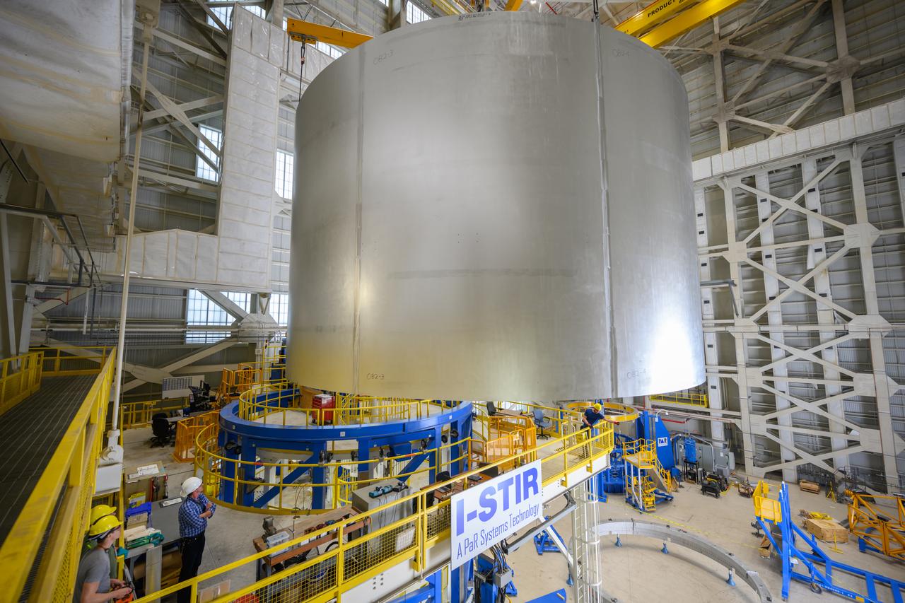 Move crews at NASA’s Michoud Assembly Facility lift the aft liquid oxygen tank (LOX) barrel out of the Vertical Weld Center (VWC) for its next phase of production. The aft barrel will eventually be mated with the forward barrel and the forward and aft domes to form the LOX tank, which will be used in the Space Launch System’s (SLS) Artemis IV mission. The LOX tank holds 196,000 gallons of super-cooled liquid oxygen to help fuel four RS-25 engines. The SLS core stage is made up of five unique elements: the forward skirt, liquid oxygen tank, intertank, liquid hydrogen tank, and the engine section. The liquid oxygen hardware, along with the liquid hydrogen tank will provide propellant to the four RS-25 engines to produce more than two million pounds of thrust to help launch NASA’s Orion spacecraft, astronauts, and supplies beyond Earth’s orbit to the Moon. Together with its four RS-25 engines, the rocket’s massive 212-foot-tall core stage — the largest stage NASA has ever built — and its twin solid rocket boosters will produce 8.8 million pounds of thrust to send NASA’s Orion spacecraft, astronauts, and supplies beyond Earth’s orbit to the Moon and, ultimately, Mars. Offering more payload mass, volume capability and energy to speed missions through space, the SLS rocket, along with NASA’s Gateway in lunar orbit, the Human Landing System, and Orion spacecraft, is part of NASA’s backbone for deep space exploration and the Artemis lunar program. No other rocket is capable of carrying astronauts in Orion around the Moon in a single mission. Photographed on Tuesday, May 10, 2022