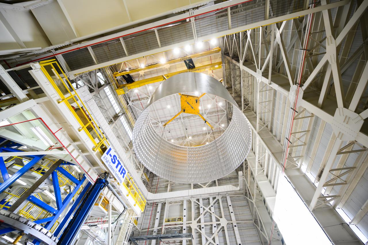 Move crews at NASA’s Michoud Assembly Facility lift the aft liquid oxygen tank (LOX) barrel out of the Vertical Weld Center (VWC) for its next phase of production. The aft barrel will eventually be mated with the forward barrel and the forward and aft domes to form the LOX tank, which will be used in the Space Launch System’s (SLS) Artemis IV mission. The LOX tank holds 196,000 gallons of super-cooled liquid oxygen to help fuel four RS-25 engines. The SLS core stage is made up of five unique elements: the forward skirt, liquid oxygen tank, intertank, liquid hydrogen tank, and the engine section. The liquid oxygen hardware, along with the liquid hydrogen tank will provide propellant to the four RS-25 engines to produce more than two million pounds of thrust to help launch NASA’s Orion spacecraft, astronauts, and supplies beyond Earth’s orbit to the Moon. Together with its four RS-25 engines, the rocket’s massive 212-foot-tall core stage — the largest stage NASA has ever built — and its twin solid rocket boosters will produce 8.8 million pounds of thrust to send NASA’s Orion spacecraft, astronauts, and supplies beyond Earth’s orbit to the Moon and, ultimately, Mars. Offering more payload mass, volume capability and energy to speed missions through space, the SLS rocket, along with NASA’s Gateway in lunar orbit, the Human Landing System, and Orion spacecraft, is part of NASA’s backbone for deep space exploration and the Artemis lunar program. No other rocket is capable of carrying astronauts in Orion around the Moon in a single mission. Photographed on Tuesday, May 10, 2022