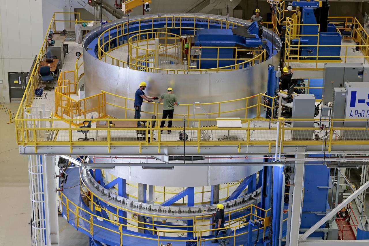 Move crews at NASA’s Michoud Assembly Facility lift the aft liquid oxygen tank (LOX) barrel out of the Vertical Weld Center (VWC) for its next phase of production. The aft barrel will eventually be mated with the forward barrel and the forward and aft domes to form the LOX tank, which will be used in the Space Launch System’s (SLS) Artemis IV mission.   The LOX tank holds 196,000 gallons of super-cooled liquid oxygen to help fuel four RS-25 engines. The SLS core stage is made up of five unique elements: the forward skirt, liquid oxygen tank, intertank, liquid hydrogen tank, and the engine section. The liquid oxygen hardware, along with the liquid hydrogen tank will provide propellant to the four RS-25 engines to produce more than two million pounds of thrust to help launch NASA’s Orion spacecraft, astronauts, and supplies beyond Earth’s orbit to the Moon. Together with its four RS-25 engines, the rocket’s massive 212-foot-tall core stage — the largest stage NASA has ever built — and its twin solid rocket boosters will produce 8.8 million pounds of thrust to send NASA’s Orion spacecraft, astronauts, and supplies beyond Earth’s orbit to the Moon and, ultimately, Mars. Offering more payload mass, volume capability and energy to speed missions through space, the SLS rocket, along with NASA’s Gateway in lunar orbit, the Human Landing System, and Orion spacecraft, is part of NASA’s backbone for deep space exploration and the Artemis lunar program. No other rocket is capable of carrying astronauts in Orion around the Moon in a single mission. Photographed on Tuesday, May 10, 2022.  Image credit: NASA/Michael DeMocker