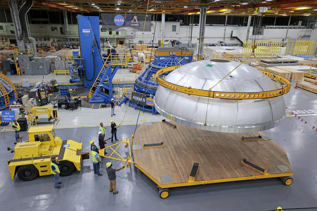 Teams completed the welding of the Artemis III core stage liquid oxygen tank dome at the NASA’s Michoud Assembly Facility in New Orleans. Crews moved the dome, which is the top of the tank.  The dome was moved to an assembly area where it will be loaded into a robotic welder that will join it with  the forward barrel to create half of the liquid oxygen tank. Later another barrel and dome will be added to complete the entire tank. The Space Launch System (SLS) core stage liquid oxygen tank holds 196,000 gallons of super-cooled liquid propellant that serves as one of the propellants for the four RS-25 engines. The SLS core stage is made up of five unique elements: the forward skirt, liquid oxygen tank, intertank, liquid hydrogen tank, and the engine section. The liquid oxygen and the liquid hydrogen tank will provide propellant to the four RS-25 engines to produce more than two million pounds of thrust to help launch NASA’s Orion spacecraft, astronauts, and supplies beyond Earth’s orbit to the Moon. Image credit: NASA/Michael DeMocker