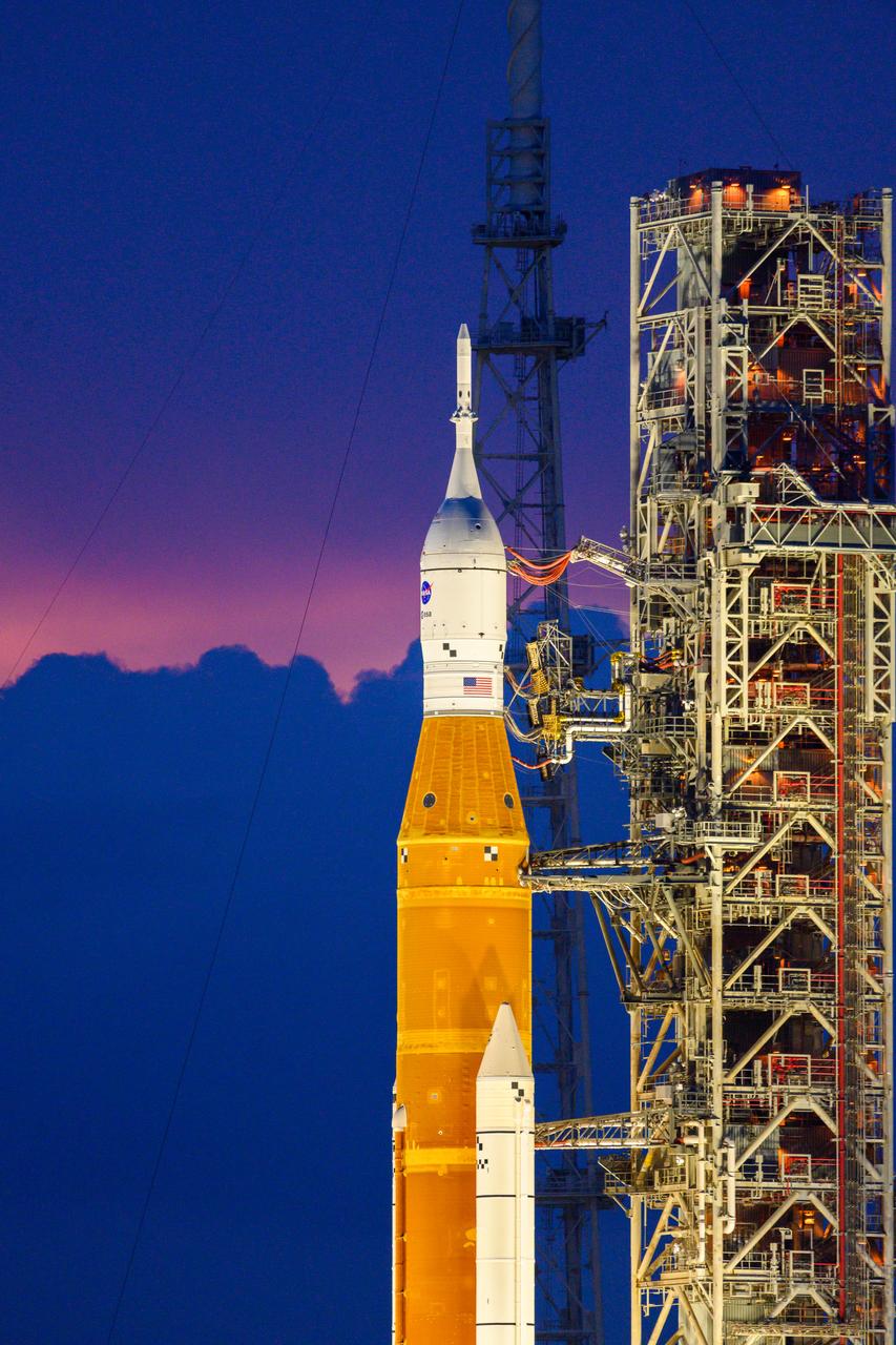 NASA’s Space Launch System (SLS) rocket with the Orion spacecraft aboard is seen atop the mobile launcher at Launch 39B at NASA’s Kennedy Space Center in Florida. Artemis I mission is the first integrated test of the agency’s deep space exploration systems: the Space Launch System rocket, Orion spacecraft, and supporting ground systems. The mission is the first in a series of increasingly complex missions to the Moon. Launch of the uncrewed flight test is targeted for no earlier than Sept. 3 at 2:17 p.m. ET. With Artemis missions, NASA will land the first woman and first person of color on the Moon, using innovative technologies to explore more of the lunar surface than ever before.