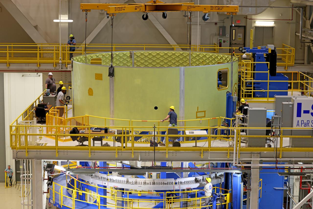 Crews at NASA’s Michoud Assembly Facility in New Orleans lift the forward skirt of a core stage that will power NASA’s Space Launch System (SLS) rocket out of the Vertical Weld Center Sept. 16, 2022. The forward skirt will be used for NASA’s Artemis IV mission. The hardware houses flight computers, cameras, and avionics systems for the SLS rocket. The SLS core stage is made up of five unique elements: the forward skirt, liquid oxygen tank, intertank, liquid hydrogen tank, and the engine section. When fully stacked, the forward skirt is located at the top of the 212-foot-tall core stage and connects to the upper part of the rocket. The core stage and its four RS-25 engines provide more than 2 million pounds of thrust to help power NASA’s next-generation lunar missions. Image credit: NASA/Michael DeMocker 
