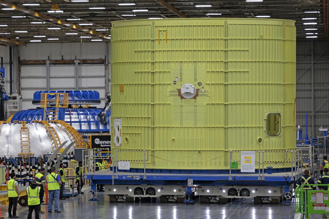 Technicians at NASA’s Michoud Assembly Facility move the intertank of NASA’s Space Launch System rocket for Artemis III to Cell G on October 26, 2022 to await application of the thermal protection system. Thermal protection systems protect space vehicles from aerodynamic heating during entry to planet atmosphere and re-entry to earth atmosphere.  The intertank lays between the liquid hydrogen tank and liquid oxygen tank. Together with the engine section and the forward skirt, they comprise the SLS core stage. The liquid hydrogen tank and liquid oxygen tank hold 733,000 gallons of propellant to power the stage’s four RS-25 engines needed for liftoff and Artemis missions to the Moon and future missions to Mars.  Image credit: NASA/Michael DeMocker