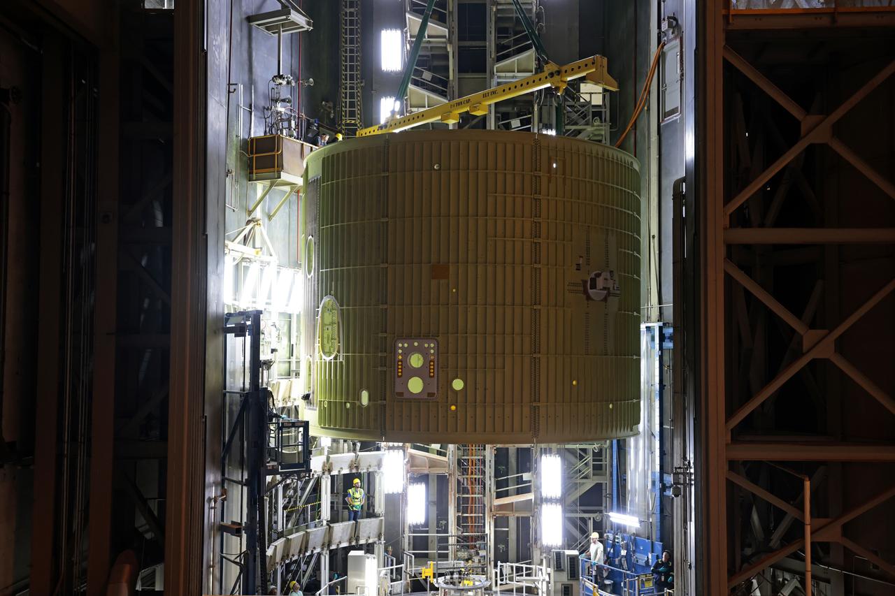 Technicians at NASA’s Michoud Assembly Facility move the intertank of NASA’s Space Launch System rocket for Artemis III to Cell G on October 26, 2022 to await application of the thermal protection system. Thermal protection systems protect space vehicles from aerodynamic heating during entry to planet atmosphere and re-entry to earth atmosphere.  The intertank lays between the liquid hydrogen tank and liquid oxygen tank. Together with the engine section and the forward skirt, they comprise the SLS core stage. The liquid hydrogen tank and liquid oxygen tank hold 733,000 gallons of propellant to power the stage’s four RS-25 engines needed for liftoff and Artemis missions to the Moon and future missions to Mars.  Image credit: NASA/Michael DeMocker