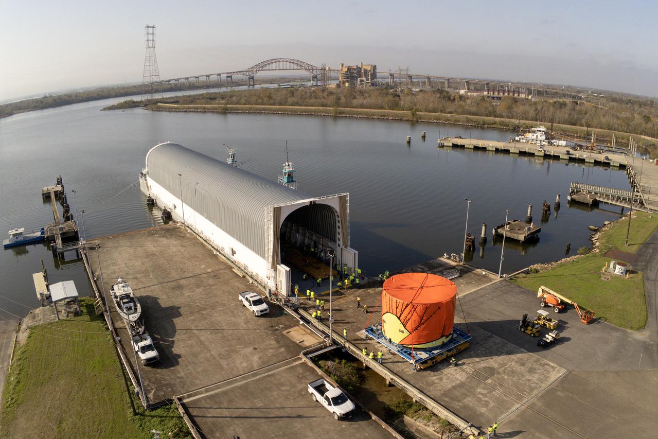 Teams at NASA’s Michoud Assembly Facility in New Orleans move the engine section flight hardware to the agency’s Pegasus barge on Sunday, December 4, 2022. The barge will ferry the engine section of NASA’s Space Launch System (SLS) rocket for Artemis III to the agency’s Kennedy Space Center in Florida. Once there, teams at Kennedy will finish outfitting the engine section, which comprises the tail-end of the rocket’s 212-foot-tall core stage, before integrating it to the rest of the stage. Beginning with production for Artemis III, NASA and core stage lead contractor Boeing will use Michoud, where the SLS core stages are currently manufactured, to produce and outfit the core stage’s five elements, and available space at Kennedy for final assembly and integration.  Image credit: NASA/Michael DeMocker