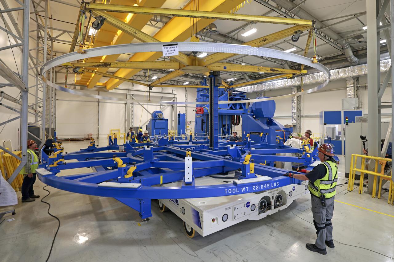 Technicians at NASA’s Michoud Assembly Facility in New Orleans lift a ring for the Exploration Upper Stage (EUS) of the SLS (Space Launch System) rocket to move it to another location in the 43-acre factory for further inspection and production. Flight hardware of the SLS EUS, a more powerful in-space propulsion stage beginning with Artemis IV, is in early production at Michoud. The rings make up the barrel sections for the flight hardware. The Exploration Upper Stage will be used on the second configuration of the SLS rocket, known as Block 1B, and will provide in-space propulsion to send astronauts in NASA’s Orion spacecraft and heavy cargo on a precise trajectory to the Moon. EUS will replace the interim cryogenic propulsion stage for the Block 1 configuration of SLS. It has larger propellant tanks and four RL10 engines, enabling SLS to launch 40% more cargo to the Moon along with crew. NASA and Boeing, the SLS lead contractor for the core stage and EUS, are currently manufacturing stages for Artemis II, III, IV, and V at the factory. NASA is working to land the first woman and first person of color on the Moon under Artemis. SLS is part of NASA’s backbone for deep space exploration, along with Orion and the Gateway in orbit around the Moon. SLS is the only rocket that can send Orion, astronauts, and supplies to the Moon in a single mission.