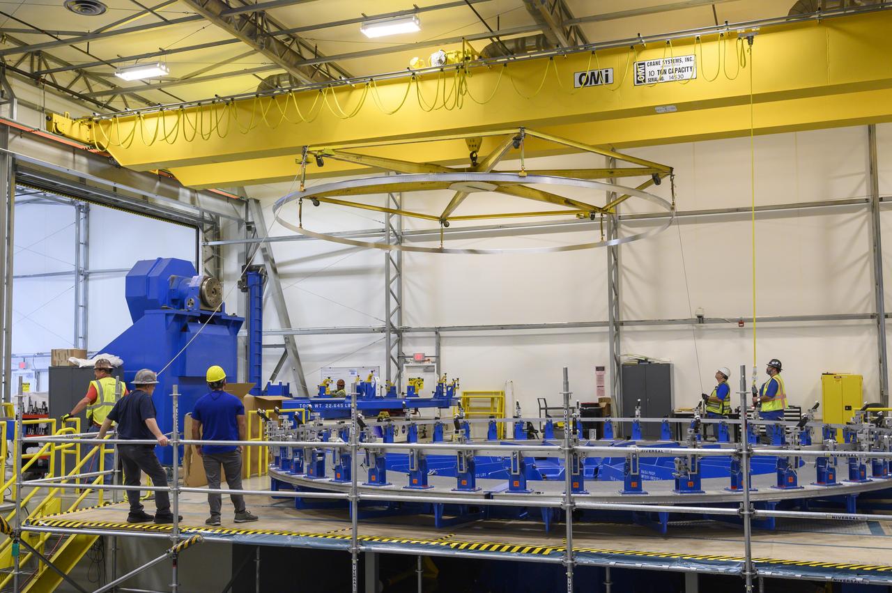Technicians at NASA’s Michoud Assembly Facility in New Orleans lift a ring for the Exploration Upper Stage (EUS) of the SLS (Space Launch System) rocket to move it to another location in the 43-acre factory for further inspection and production. Flight hardware of the SLS EUS, a more powerful in-space propulsion stage beginning with Artemis IV, is in early production at Michoud. The rings make up the barrel sections for the flight hardware. The Exploration Upper Stage will be used on the second configuration of the SLS rocket, known as Block 1B, and will provide in-space propulsion to send astronauts in NASA’s Orion spacecraft and heavy cargo on a precise trajectory to the Moon. EUS will replace the interim cryogenic propulsion stage for the Block 1 configuration of SLS. It has larger propellant tanks and four RL10 engines, enabling SLS to launch 40% more cargo to the Moon along with crew. NASA and Boeing, the SLS lead contractor for the core stage and EUS, are currently manufacturing stages for Artemis II, III, IV, and V at the factory. NASA is working to land the first woman and first person of color on the Moon under Artemis. SLS is part of NASA’s backbone for deep space exploration, along with Orion and the Gateway in orbit around the Moon. SLS is the only rocket that can send Orion, astronauts, and supplies to the Moon in a single mission.