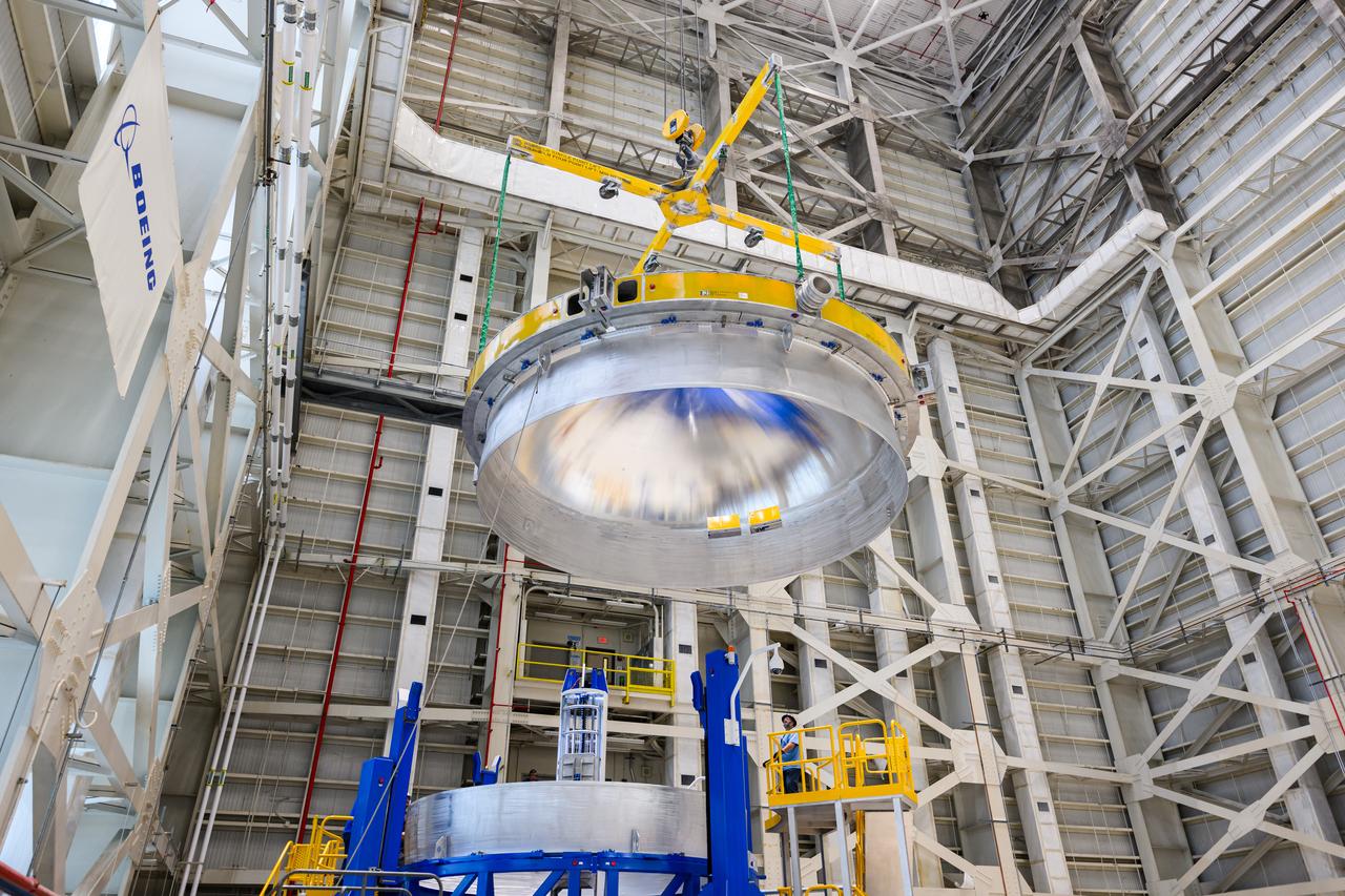 These images show technicians at NASA’s Michoud Assembly Facility in New Orleans lifting and installing the liquid oxygen dome weld confidence article for a future upper stage for NASA’s SLS (Space Launch System) rocket onto the LTAC (LOX Tank Assembly Center) in Building 115 at Michoud for the next phase of manufacturing in July 2023.  The dome makes up a portion of the liquid oxygen tank weld confidence article for the EUS (exploration upper stage). Teams use weld confidence articles to verify welding procedures and structural integrity of the welds to manufacture structural test and flight versions of the hardware.  EUS flight hardware is in early production at Michoud. The more powerful upper stage and its four RL10 engines will be used on the second configuration of the SLS rocket, known as Block 1B, and will provide in-space propulsion to send astronauts in NASA’s Orion spacecraft and heavy cargo on a precise trajectory to the Moon. NASA and Boeing, the lead contractor for the SLS core stage and EUS, are manufacturing SLS stages for Artemis II, III, IV, and V at the facility.   NASA is working to land the first woman and first person of color on the Moon under Artemis. SLS is part of NASA’s backbone for deep space exploration, along with Orion and the Gateway in orbit around the Moon. SLS is the only rocket that can send Orion, astronauts, and supplies to the Moon in a single mission. 