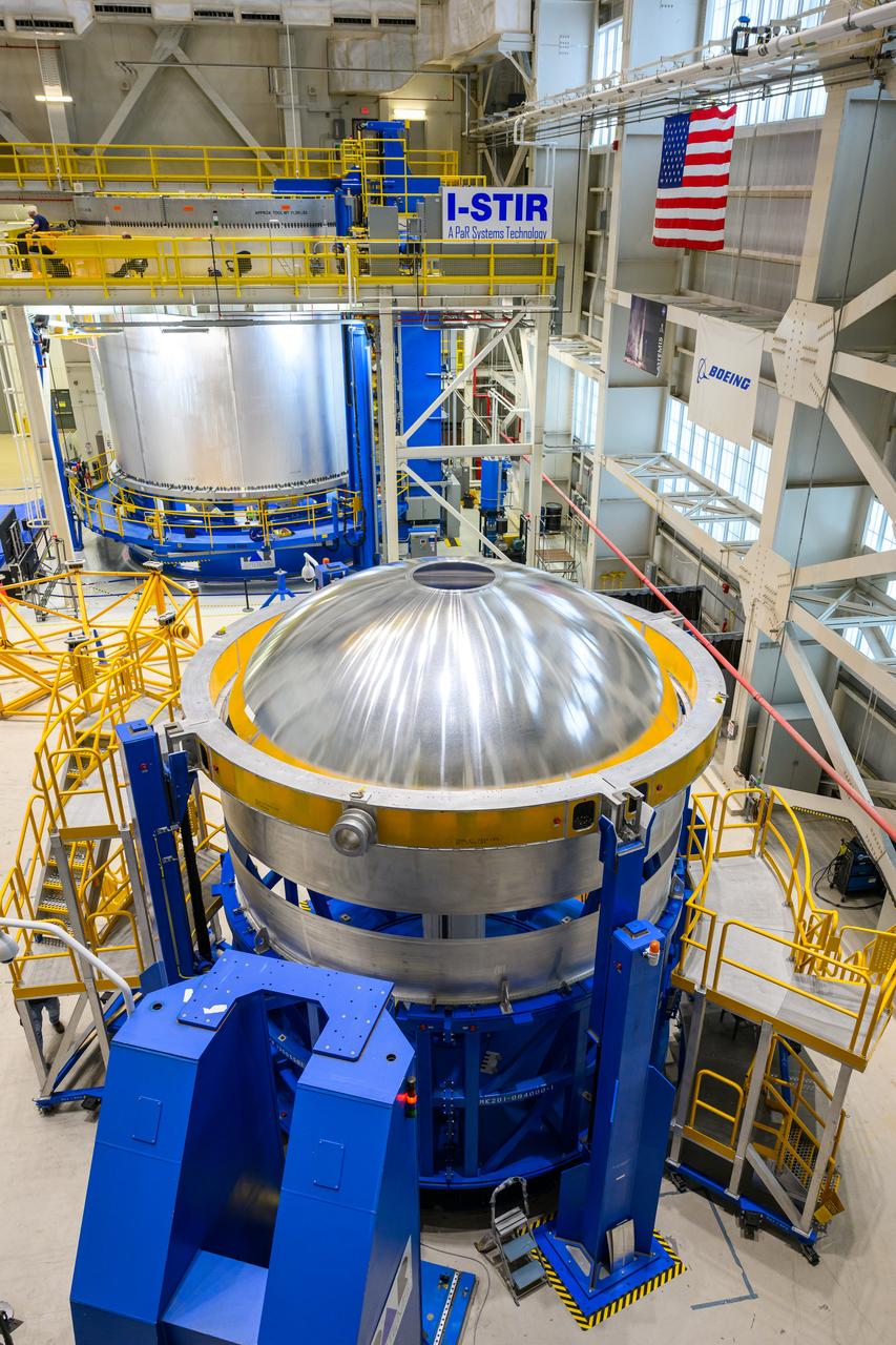 These images show technicians at NASA’s Michoud Assembly Facility in New Orleans lifting and installing the liquid oxygen dome weld confidence article for a future upper stage for NASA’s SLS (Space Launch System) rocket onto the LTAC (LOX Tank Assembly Center) in Building 115 at Michoud for the next phase of manufacturing in July 2023.  The dome makes up a portion of the liquid oxygen tank weld confidence article for the EUS (exploration upper stage). Teams use weld confidence articles to verify welding procedures and structural integrity of the welds to manufacture structural test and flight versions of the hardware.  EUS flight hardware is in early production at Michoud. The more powerful upper stage and its four RL10 engines will be used on the second configuration of the SLS rocket, known as Block 1B, and will provide in-space propulsion to send astronauts in NASA’s Orion spacecraft and heavy cargo on a precise trajectory to the Moon. NASA and Boeing, the lead contractor for the SLS core stage and EUS, are manufacturing SLS stages for Artemis II, III, IV, and V at the facility.   NASA is working to land the first woman and first person of color on the Moon under Artemis. SLS is part of NASA’s backbone for deep space exploration, along with Orion and the Gateway in orbit around the Moon. SLS is the only rocket that can send Orion, astronauts, and supplies to the Moon in a single mission. 