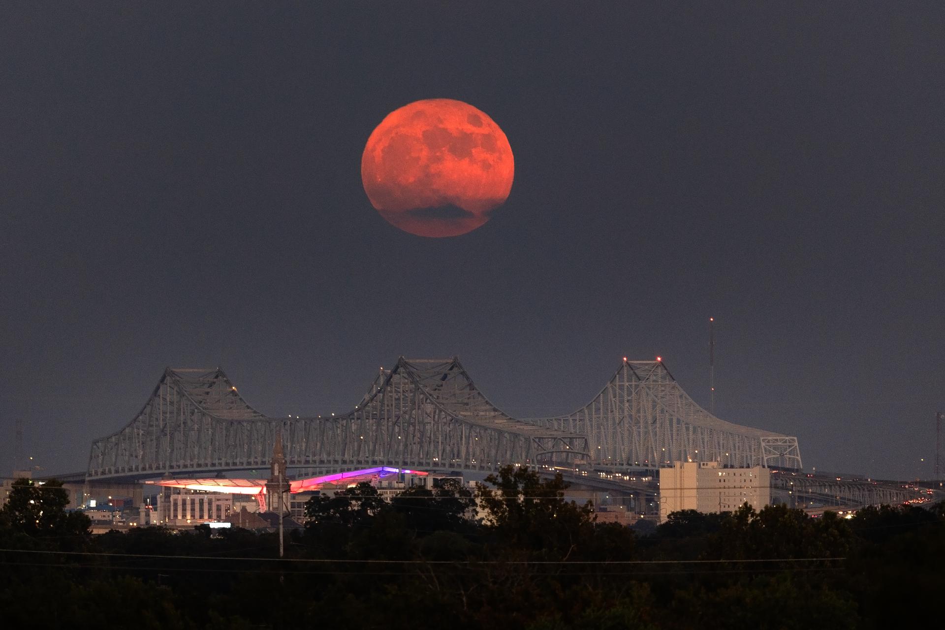 A Super Blue Moon rises above the Mississippi River and the Crescent City Connection Bridge in New Orleans, Aug. 30. The full moon is “super” because it’s slightly closer to Earth and “blue” because it’s the second full moon in a month. About 25% of all full moons are supermoons, but only 3% of full moons are blue moons. The next super blue moons will occur in a pair in January and March 2037. New Orleans is home to NASA’s Michoud Assembly Facility, where stages for NASA’s SLS (Space Launch System) rocket and structures for Orion spacecraft are produced for the Artemis missions.