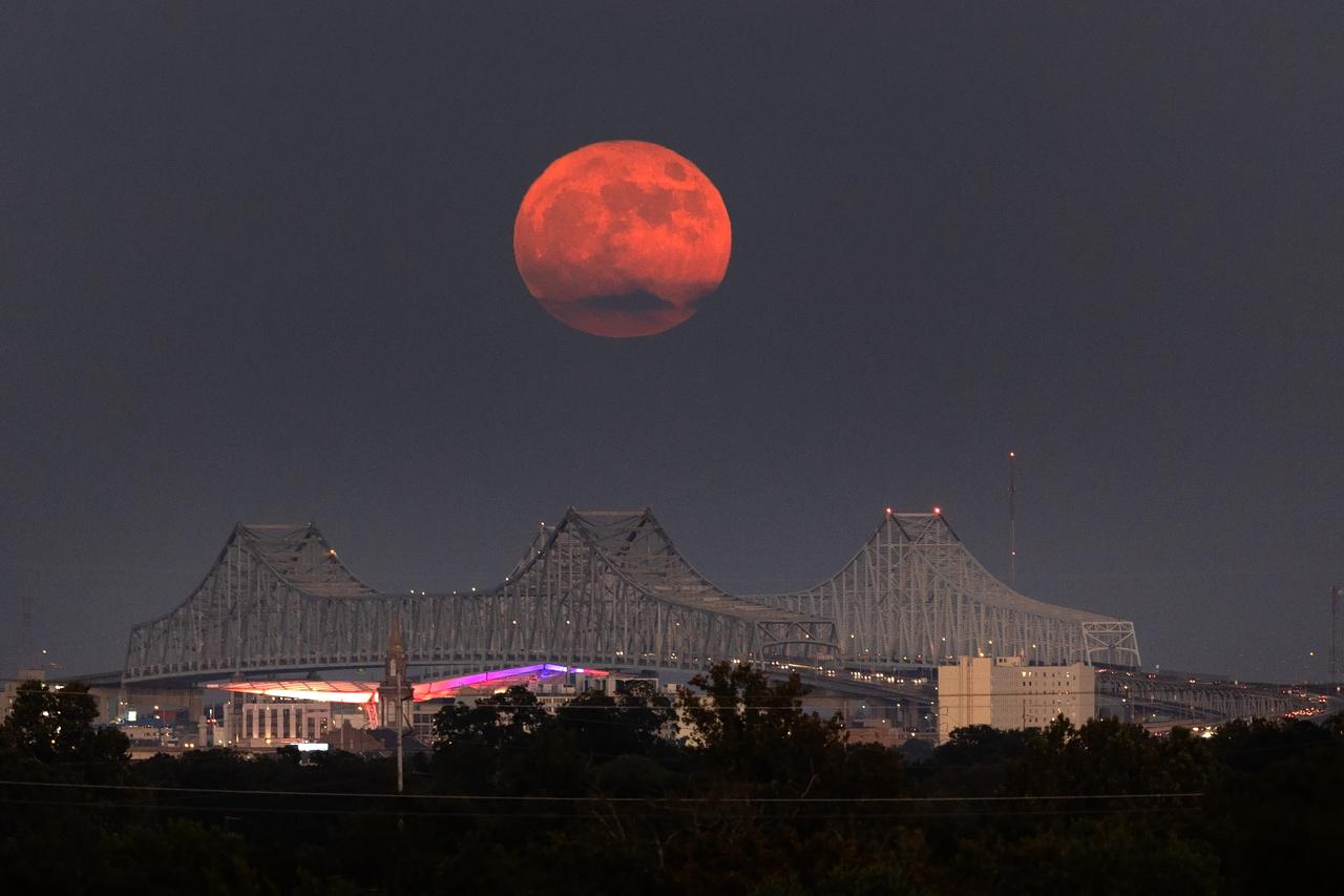A Super Blue Moon rises above the Mississippi River and the Crescent City Connection Bridge in New Orleans, Aug. 30. The full moon is “super” because it’s slightly closer to Earth and “blue” because it’s the second full moon in a month. About 25% of all full moons are supermoons, but only 3% of full moons are blue moons. The next super blue moons will occur in a pair in January and March 2037. New Orleans is home to NASA’s Michoud Assembly Facility, where stages for NASA’s SLS (Space Launch System) rocket and structures for Orion spacecraft are produced for the Artemis missions. 