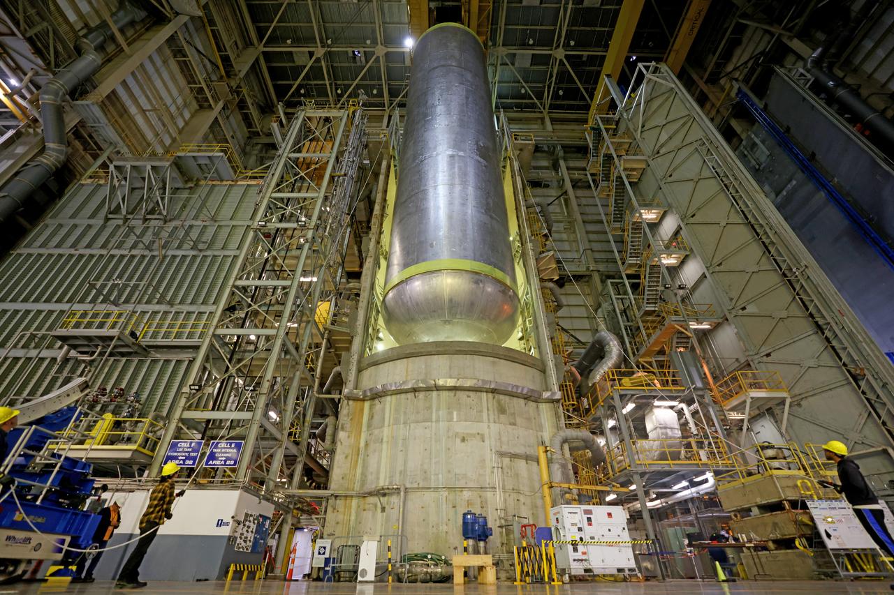 These photos show how teams moved and prepared a liquid hydrogen tank for the SLS (Space Launch System) rocket for priming in the Vertical Assembly Building at NASA’s Michoud Assembly Facility in New Orleans Nov. 14, 2023. The hardware will form part of the core stage for the SLS rocket that will power Artemis III. To prepare the flight hardware for primer, the tank underwent internal cleaning in nearby Cell E in October. Internal cleaning is part of the manufacturing process for the core stage. After testing, both of the stage’s propellant tanks and its dry structures – the elements that do not hold fuel – are cleaned, primed, and readied for the next phase of production Technichians will next sand down and prepare the surface of the tank before coating it in a primer. Primer is applied to the barrel section of the tank by an automated robotic tool, whereas the forward and aft domes are primed manually.  The propellant tank is the largest of the five major elements that make up the 212-foot-tall Moon rocket stage. The core stage, along with its four RS-25 engines, produce two million pounds of thrust to help launch NASA’s Orion spacecraft, astronauts, and supplies beyond Earth’s orbit and to the lunar surface for Artemis.  Image credit: NASA/Michael DeMocker