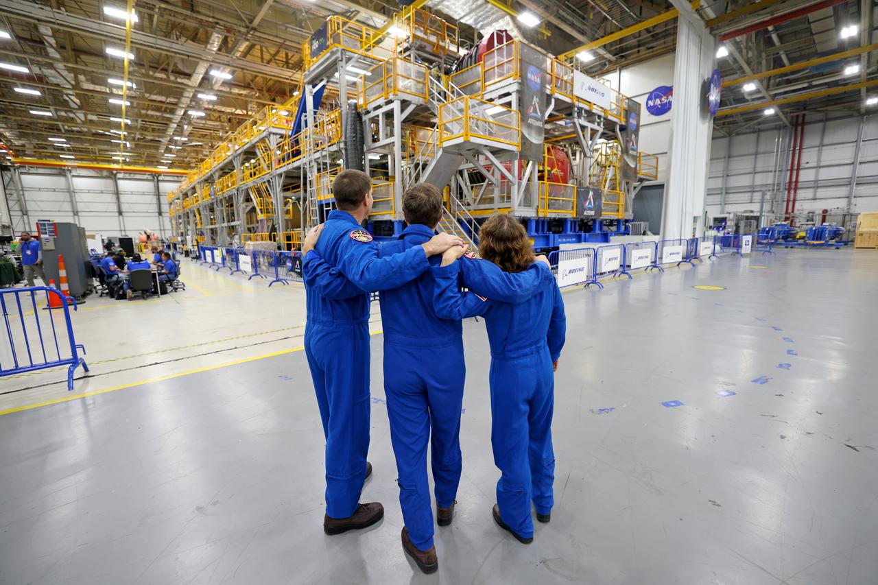 Artemis II NASA astronauts Reid Wiseman and Christina Koch of NASA and CSA (Canadian Space Agency) astronaut Jeremy Hansen view the core stage for the SLS (Space Launch System) rocket at the agency’s Michoud Assembly Facility in New Orleans on Nov. 16. The three astronauts, along with NASA’s Victor Glover, will launch atop the rocket stage to venture around the Moon on Artemis II, the first crewed flight for Artemis. The SLS core stage, towering at 212 feet, is the backbone of the Moon rocket and includes two massive propellant tanks that collectively hold 733,000 gallons of propellant to help power the stage’s four RS-25 engines. NASA is working to land the first woman and first person of color on the Moon under Artemis. SLS is part of NASA’s backbone for deep space exploration, along with Orion and the Gateway in orbit around the Moon. SLS is the only rocket that can send Orion, astronauts, and supplies to the Moon in a single mission.
