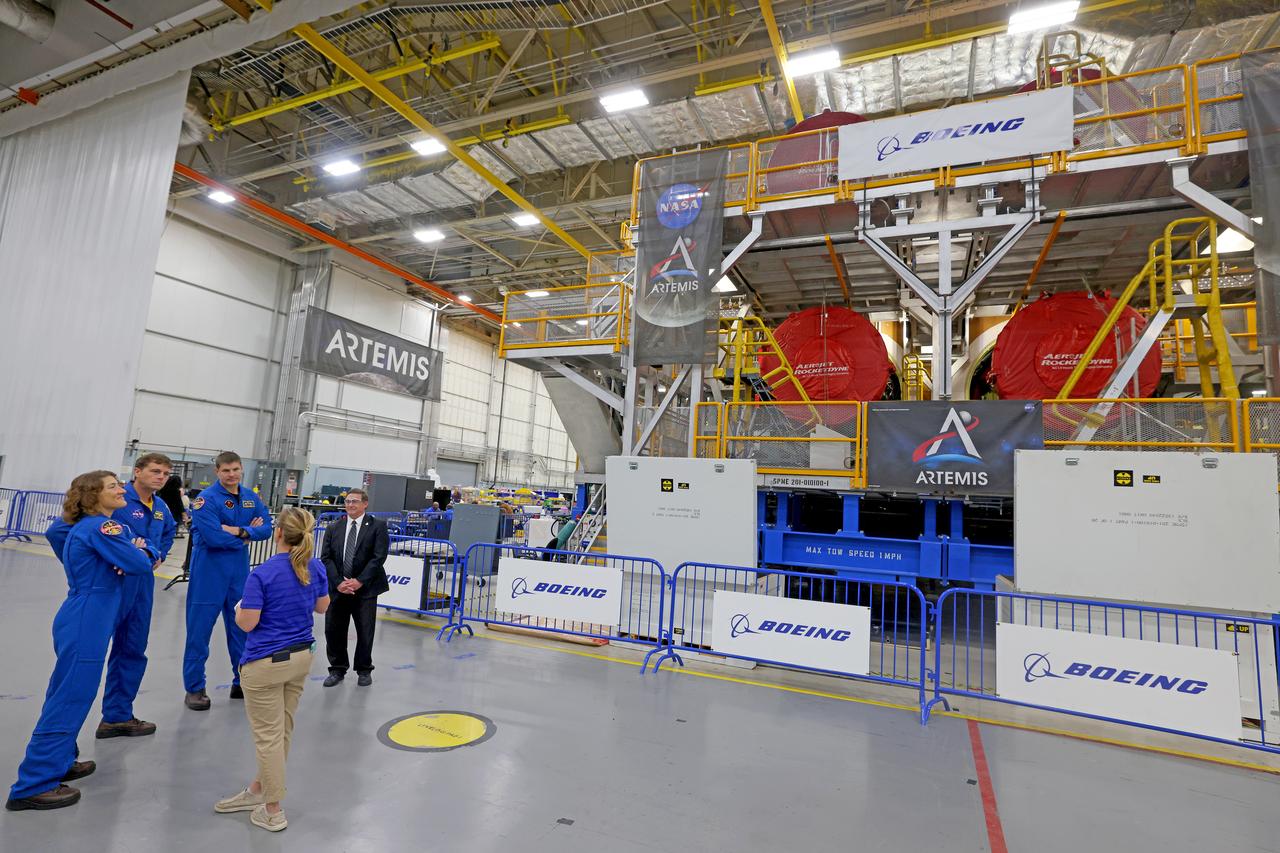 Artemis II NASA astronauts Reid Wiseman and Christina Koch of NASA and CSA (Canadian Space Agency) astronaut Jeremy Hansen view the core stage for the SLS (Space Launch System) rocket at the agency’s Michoud Assembly Facility in New Orleans on Nov. 16. The three astronauts, along with NASA’s Victor Glover, will launch atop the rocket stage to venture around the Moon on Artemis II, the first crewed flight for Artemis. The SLS core stage, towering at 212 feet, is the backbone of the Moon rocket and includes two massive propellant tanks that collectively hold 733,000 gallons of propellant to help power the stage’s four RS-25 engines. NASA is working to land the first woman and first person of color on the Moon under Artemis. SLS is part of NASA’s backbone for deep space exploration, along with Orion and the Gateway in orbit around the Moon. SLS is the only rocket that can send Orion, astronauts, and supplies to the Moon in a single mission.
