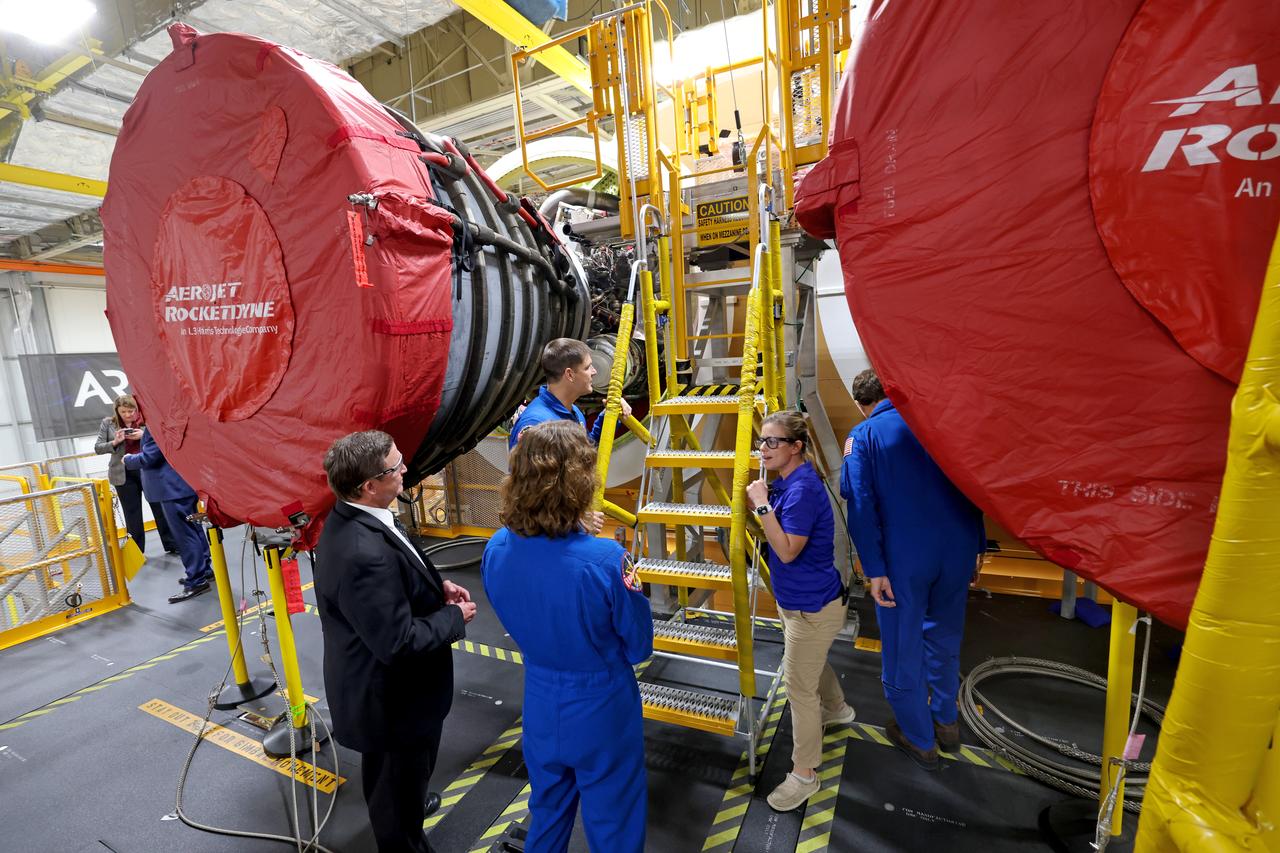 Artemis II NASA astronauts Reid Wiseman and Christina Koch of NASA and CSA (Canadian Space Agency) astronaut Jeremy Hansen view the core stage for the SLS (Space Launch System) rocket at the agency’s Michoud Assembly Facility in New Orleans on Nov. 16. The three astronauts, along with NASA’s Victor Glover, will launch atop the rocket stage to venture around the Moon on Artemis II, the first crewed flight for Artemis. The SLS core stage, towering at 212 feet, is the backbone of the Moon rocket and includes two massive propellant tanks that collectively hold 733,000 gallons of propellant to help power the stage’s four RS-25 engines. NASA is working to land the first woman and first person of color on the Moon under Artemis. SLS is part of NASA’s backbone for deep space exploration, along with Orion and the Gateway in orbit around the Moon. SLS is the only rocket that can send Orion, astronauts, and supplies to the Moon in a single mission.