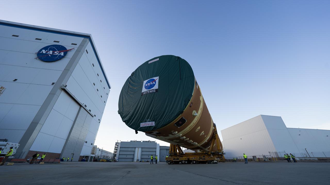 These images and videos show team members moving the first core stage that will help launch the first crewed flight of NASA’s SLS (Space Launch System) rocket for the agency’s Artemis II mission. The move marked the first time a fully assembled Moon rocket stage for a crewed mission has rolled out from NASA’s Michoud Assembly Facility in New Orleans since the Apollo Program, The core stage was moved onto the agency’s Pegasus barge, where it will be ferried to NASA’s Kennedy Space Center in Florida.  The core stage for the SLS mega rocket is the largest stage NASA has ever produced. At 212 feet tall, the stage consists of five major elements, including two huge propellant tanks that collectively hold more than 733,000 gallons of super chilled liquid propellant to feed four RS-25 engines at its base. During launch and flight, the stage will operate for just over eight minutes, producing more than 2 million pounds of thrust to help send a crew of four astronauts inside NASA’s Orion spacecraft onward to the Moon.  NASA is working to land the first woman, first person of color, and its first international partner astronaut on the Moon under Artemis. SLS is part of NASA’s backbone for deep space exploration, along with the Orion spacecraft and Gateway in orbit around the Moon and commercial human landing systems, next-generation space, next-generational spacesuits, and rovers on the lunar surface. SLS is the only rocket that can send Orion, astronauts, and supplies to the Moon in a single launch. 
