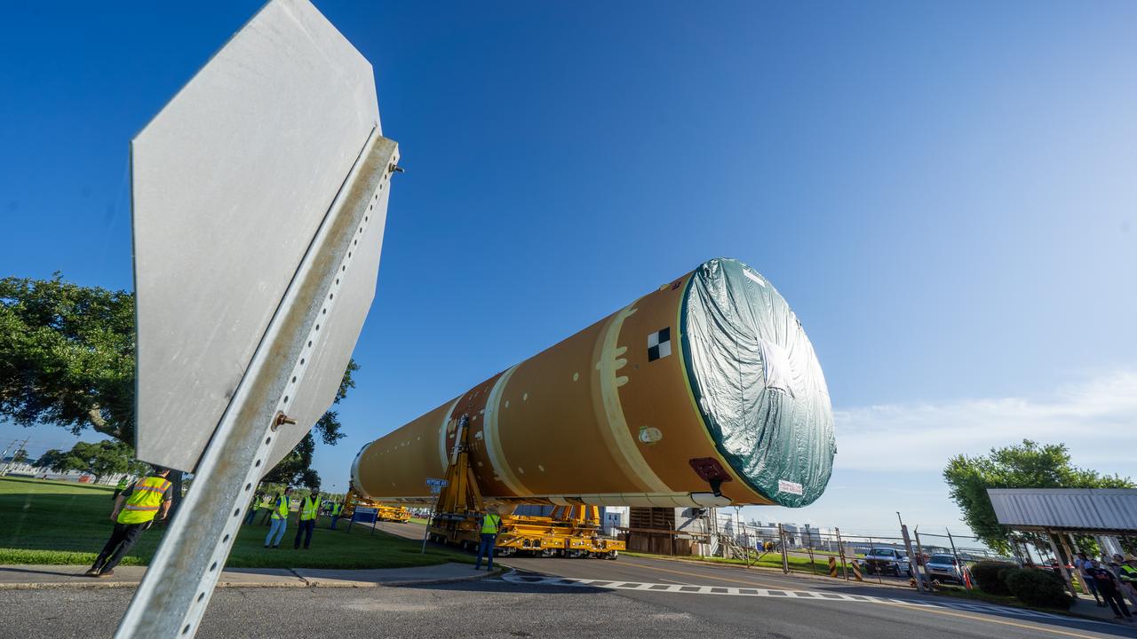 These images and videos show team members moving the first core stage that will help launch the first crewed flight of NASA’s SLS (Space Launch System) rocket for the agency’s Artemis II mission. The move marked the first time a fully assembled Moon rocket stage for a crewed mission has rolled out from NASA’s Michoud Assembly Facility in New Orleans since the Apollo Program, The core stage was moved onto the agency’s Pegasus barge, where it will be ferried to NASA’s Kennedy Space Center in Florida.  The core stage for the SLS mega rocket is the largest stage NASA has ever produced. At 212 feet tall, the stage consists of five major elements, including two huge propellant tanks that collectively hold more than 733,000 gallons of super chilled liquid propellant to feed four RS-25 engines at its base. During launch and flight, the stage will operate for just over eight minutes, producing more than 2 million pounds of thrust to help send a crew of four astronauts inside NASA’s Orion spacecraft onward to the Moon.  NASA is working to land the first woman, first person of color, and its first international partner astronaut on the Moon under Artemis. SLS is part of NASA’s backbone for deep space exploration, along with the Orion spacecraft and Gateway in orbit around the Moon and commercial human landing systems, next-generation space, next-generational spacesuits, and rovers on the lunar surface. SLS is the only rocket that can send Orion, astronauts, and supplies to the Moon in a single launch. 