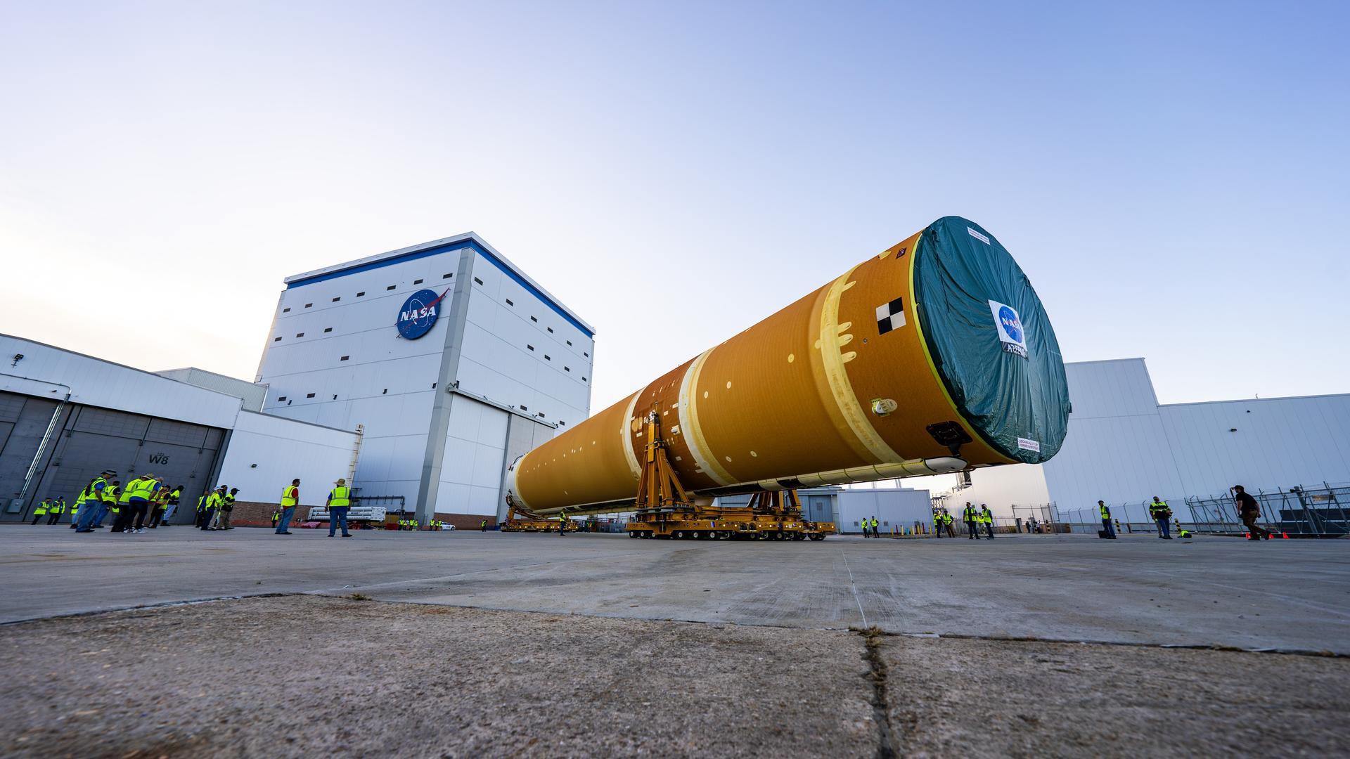 These images and videos show team members moving the first core stage that will help launch the first crewed flight of NASA’s SLS (Space Launch System) rocket for the agency’s Artemis II mission. The move marked the first time a fully assembled Moon rocket stage for a crewed mission has rolled out from NASA’s Michoud Assembly Facility in New Orleans since the Apollo Program, The core stage was moved onto the agency’s Pegasus barge, where it will be ferried to NASA’s Kennedy Space Center in Florida. The core stage for the SLS mega rocket is the largest stage NASA has ever produced. At 212 feet tall, the stage consists of five major elements, including two huge propellant tanks that collectively hold more than 733,000 gallons of super chilled liquid propellant to feed four RS-25 engines at its base. During launch and flight, the stage will operate for just over eight minutes, producing more than 2 million pounds of thrust to help send a crew of four astronauts inside NASA’s Orion spacecraft onward to the Moon. NASA is working to land the first woman, first person of color, and its first international partner astronaut on the Moon under Artemis. SLS is part of NASA’s backbone for deep space exploration, along with the Orion spacecraft and Gateway in orbit around the Moon and commercial human landing systems, next-generation space, next-generational spacesuits, and rovers on the lunar surface. SLS is the only rocket that can send Orion, astronauts, and supplies to the Moon in a single launch.