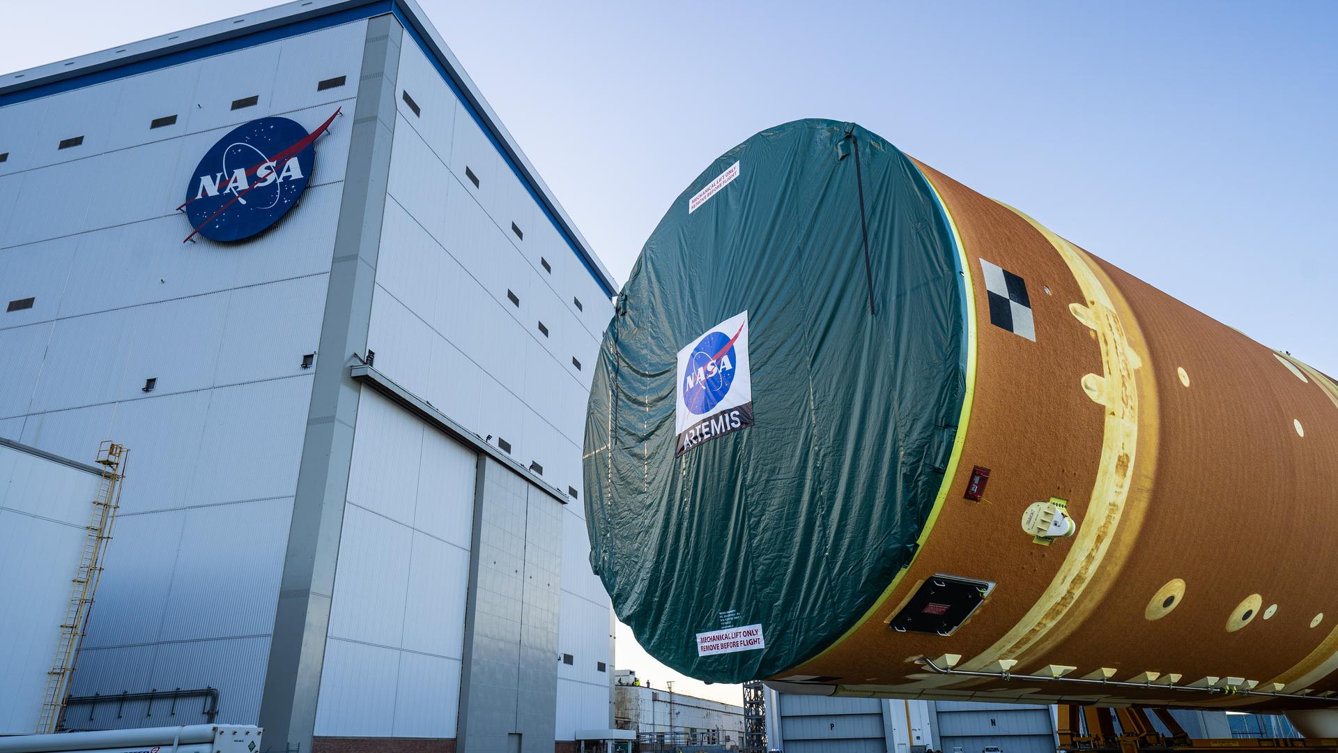 These images and videos show team members moving the first core stage that will help launch the first crewed flight of NASA’s SLS (Space Launch System) rocket for the agency’s Artemis II mission. The move marked the first time a fully assembled Moon rocket stage for a crewed mission has rolled out from NASA’s Michoud Assembly Facility in New Orleans since the Apollo Program, The core stage was moved onto the agency’s Pegasus barge, where it will be ferried to NASA’s Kennedy Space Center in Florida.  The core stage for the SLS mega rocket is the largest stage NASA has ever produced. At 212 feet tall, the stage consists of five major elements, including two huge propellant tanks that collectively hold more than 733,000 gallons of super chilled liquid propellant to feed four RS-25 engines at its base. During launch and flight, the stage will operate for just over eight minutes, producing more than 2 million pounds of thrust to help send a crew of four astronauts inside NASA’s Orion spacecraft onward to the Moon.  NASA is working to land the first woman, first person of color, and its first international partner astronaut on the Moon under Artemis. SLS is part of NASA’s backbone for deep space exploration, along with the Orion spacecraft and Gateway in orbit around the Moon and commercial human landing systems, next-generation space, next-generational spacesuits, and rovers on the lunar surface. SLS is the only rocket that can send Orion, astronauts, and supplies to the Moon in a single launch.