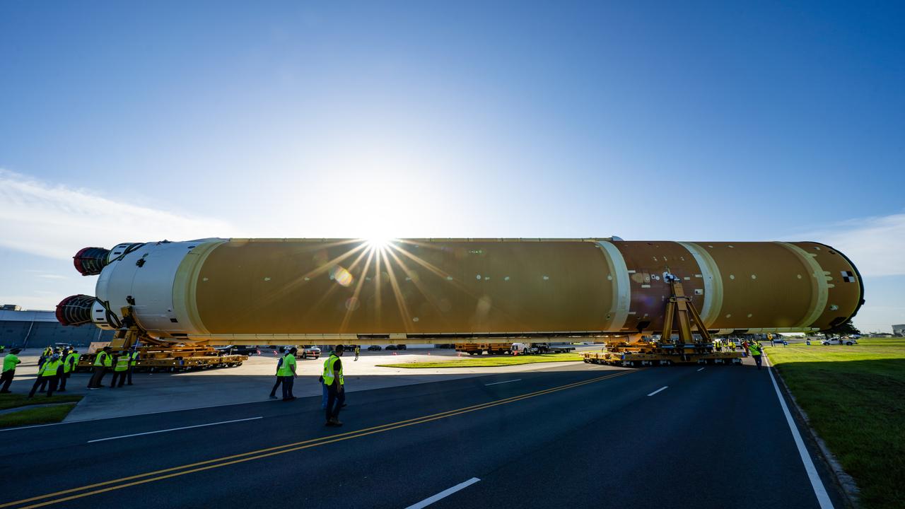 These images and videos show team members moving the first core stage that will help launch the first crewed flight of NASA’s SLS (Space Launch System) rocket for the agency’s Artemis II mission. The move marked the first time a fully assembled Moon rocket stage for a crewed mission has rolled out from NASA’s Michoud Assembly Facility in New Orleans since the Apollo Program, The core stage was moved onto the agency’s Pegasus barge, where it will be ferried to NASA’s Kennedy Space Center in Florida.  The core stage for the SLS mega rocket is the largest stage NASA has ever produced. At 212 feet tall, the stage consists of five major elements, including two huge propellant tanks that collectively hold more than 733,000 gallons of super chilled liquid propellant to feed four RS-25 engines at its base. During launch and flight, the stage will operate for just over eight minutes, producing more than 2 million pounds of thrust to help send a crew of four astronauts inside NASA’s Orion spacecraft onward to the Moon.  NASA is working to land the first woman, first person of color, and its first international partner astronaut on the Moon under Artemis. SLS is part of NASA’s backbone for deep space exploration, along with the Orion spacecraft and Gateway in orbit around the Moon and commercial human landing systems, next-generation space, next-generational spacesuits, and rovers on the lunar surface. SLS is the only rocket that can send Orion, astronauts, and supplies to the Moon in a single launch. 