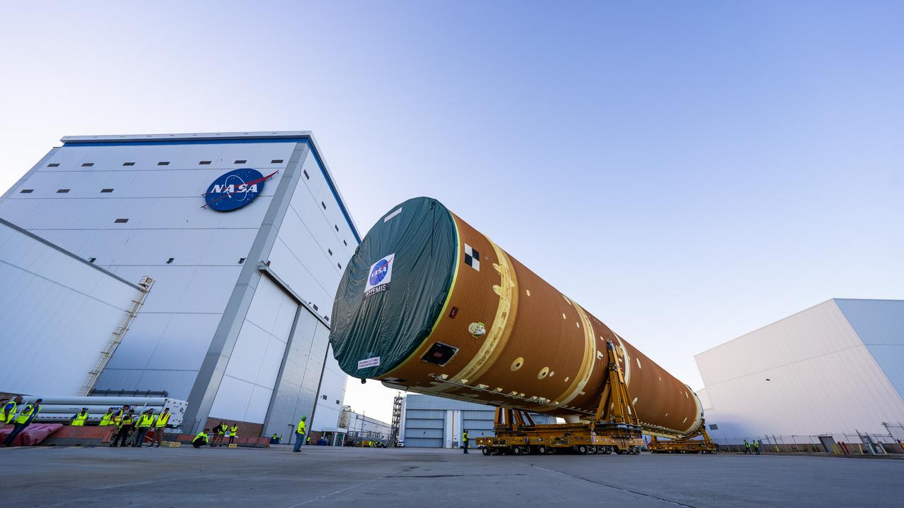These images and videos show team members moving the first core stage that will help launch the first crewed flight of NASA’s SLS (Space Launch System) rocket for the agency’s Artemis II mission. The move marked the first time a fully assembled Moon rocket stage for a crewed mission has rolled out from NASA’s Michoud Assembly Facility in New Orleans since the Apollo Program, The core stage was moved onto the agency’s Pegasus barge, where it will be ferried to NASA’s Kennedy Space Center in Florida.  The core stage for the SLS mega rocket is the largest stage NASA has ever produced. At 212 feet tall, the stage consists of five major elements, including two huge propellant tanks that collectively hold more than 733,000 gallons of super chilled liquid propellant to feed four RS-25 engines at its base. During launch and flight, the stage will operate for just over eight minutes, producing more than 2 million pounds of thrust to help send a crew of four astronauts inside NASA’s Orion spacecraft onward to the Moon.  NASA is working to land the first woman, first person of color, and its first international partner astronaut on the Moon under Artemis. SLS is part of NASA’s backbone for deep space exploration, along with the Orion spacecraft and Gateway in orbit around the Moon and commercial human landing systems, next-generation space, next-generational spacesuits, and rovers on the lunar surface. SLS is the only rocket that can send Orion, astronauts, and supplies to the Moon in a single launch. 