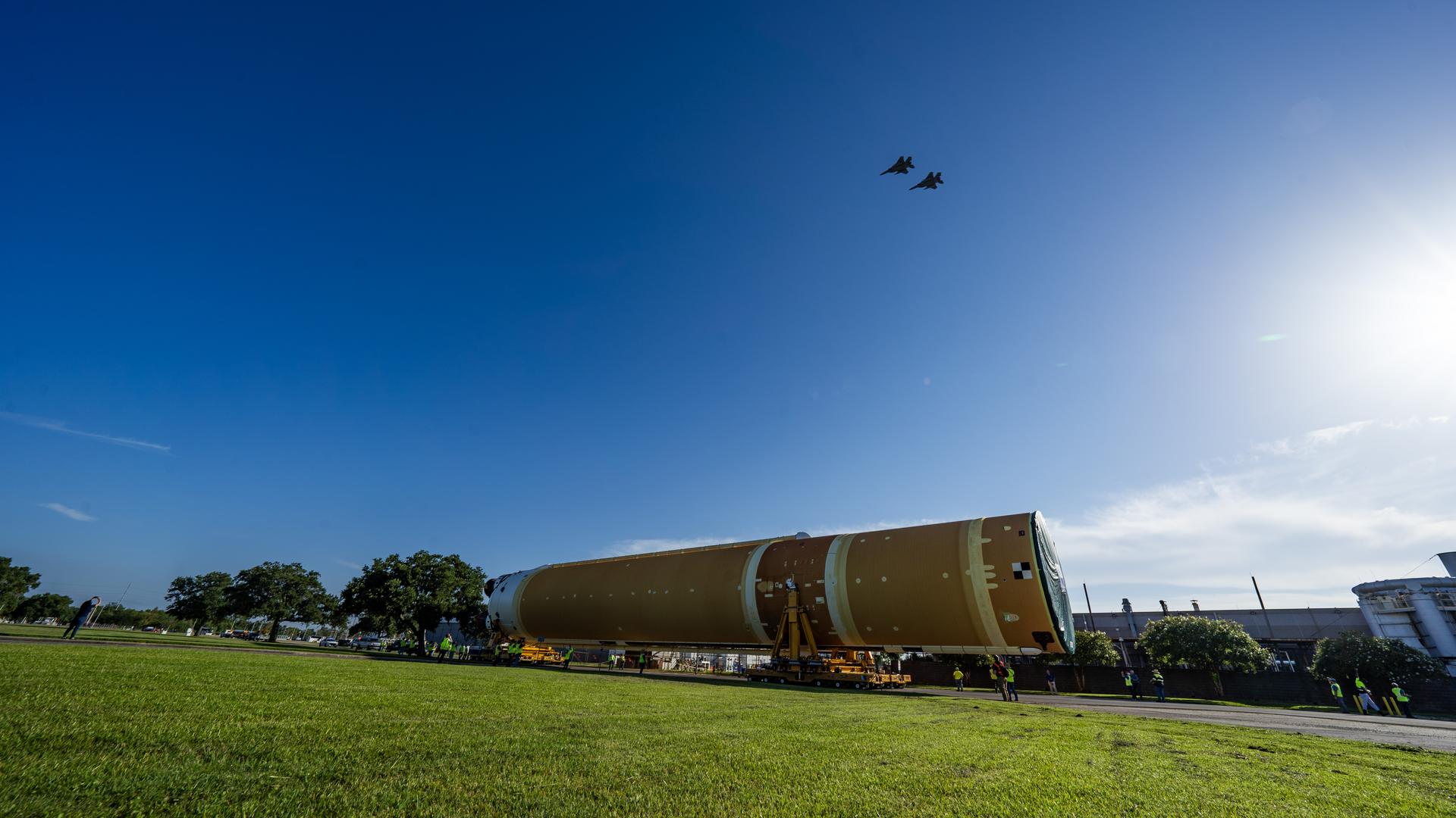 These images and videos show team members moving the first core stage that will help launch the first crewed flight of NASA’s SLS (Space Launch System) rocket for the agency’s Artemis II mission. The move marked the first time a fully assembled Moon rocket stage for a crewed mission has rolled out from NASA’s Michoud Assembly Facility in New Orleans since the Apollo Program, The core stage was moved onto the agency’s Pegasus barge, where it will be ferried to NASA’s Kennedy Space Center in Florida. The core stage for the SLS mega rocket is the largest stage NASA has ever produced. At 212 feet tall, the stage consists of five major elements, including two huge propellant tanks that collectively hold more than 733,000 gallons of super chilled liquid propellant to feed four RS-25 engines at its base. During launch and flight, the stage will operate for just over eight minutes, producing more than 2 million pounds of thrust to help send a crew of four astronauts inside NASA’s Orion spacecraft onward to the Moon. NASA is working to land the first woman, first person of color, and its first international partner astronaut on the Moon under Artemis. SLS is part of NASA’s backbone for deep space exploration, along with the Orion spacecraft and Gateway in orbit around the Moon and commercial human landing systems, next-generation space, next-generational spacesuits, and rovers on the lunar surface. SLS is the only rocket that can send Orion, astronauts, and supplies to the Moon in a single launch.