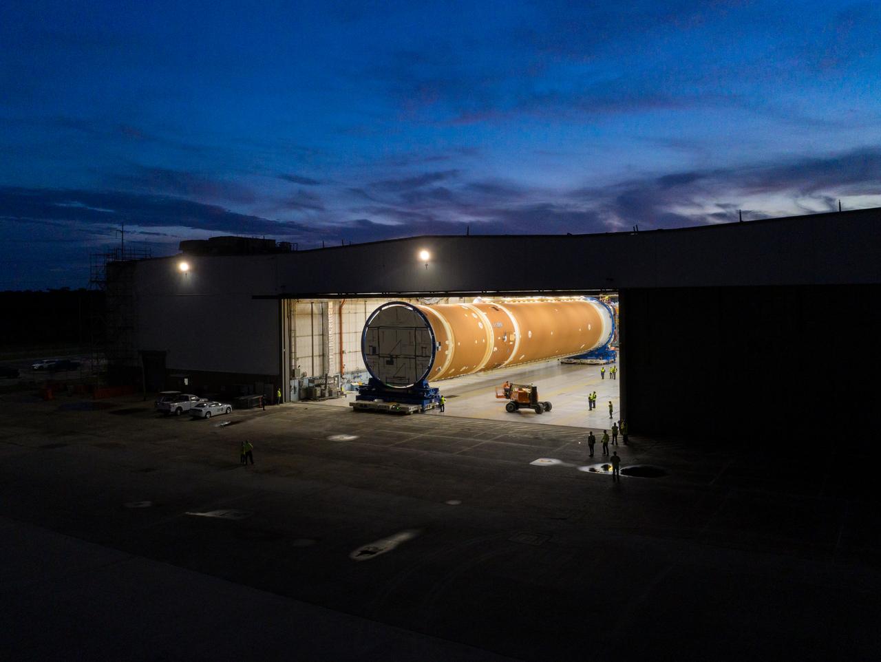 This photo shows NASA and Boeing, the SLS core stage lead contractor, preparing the SLS (Space Launch System) rocket core stage for shipment at NASA’s Michoud Assembly Facility in New Orleans. On July 6, NASA and Boeing moved the Artemis II rocket stage to Building 110. The move comes as teams prepare to roll the massive rocket stage with its four RS-25 engines to the agency’s Pegasus barge for delivery to NASA’s Kennedy Space Center in Florida in mid-July. Prior to the move, technicians began removing external access stands, or scaffolding, surrounding the core stage to assess the interior elements, including its complex avionics and flight propulsion systems. The stage is fully manufactured at NASA Michoud.  NASA is working to land the first woman, first person of color, and its first international partner astronaut on the Moon under Artemis. SLS is part of NASA’s backbone for deep space exploration, along with the Orion spacecraft, supporting ground systems, advanced spacesuits and rovers, the Gateway in orbit around the Moon, and commercial human landing systems. SLS is the only rocket that can send Orion, astronauts, and supplies to the Moon in a single launch.