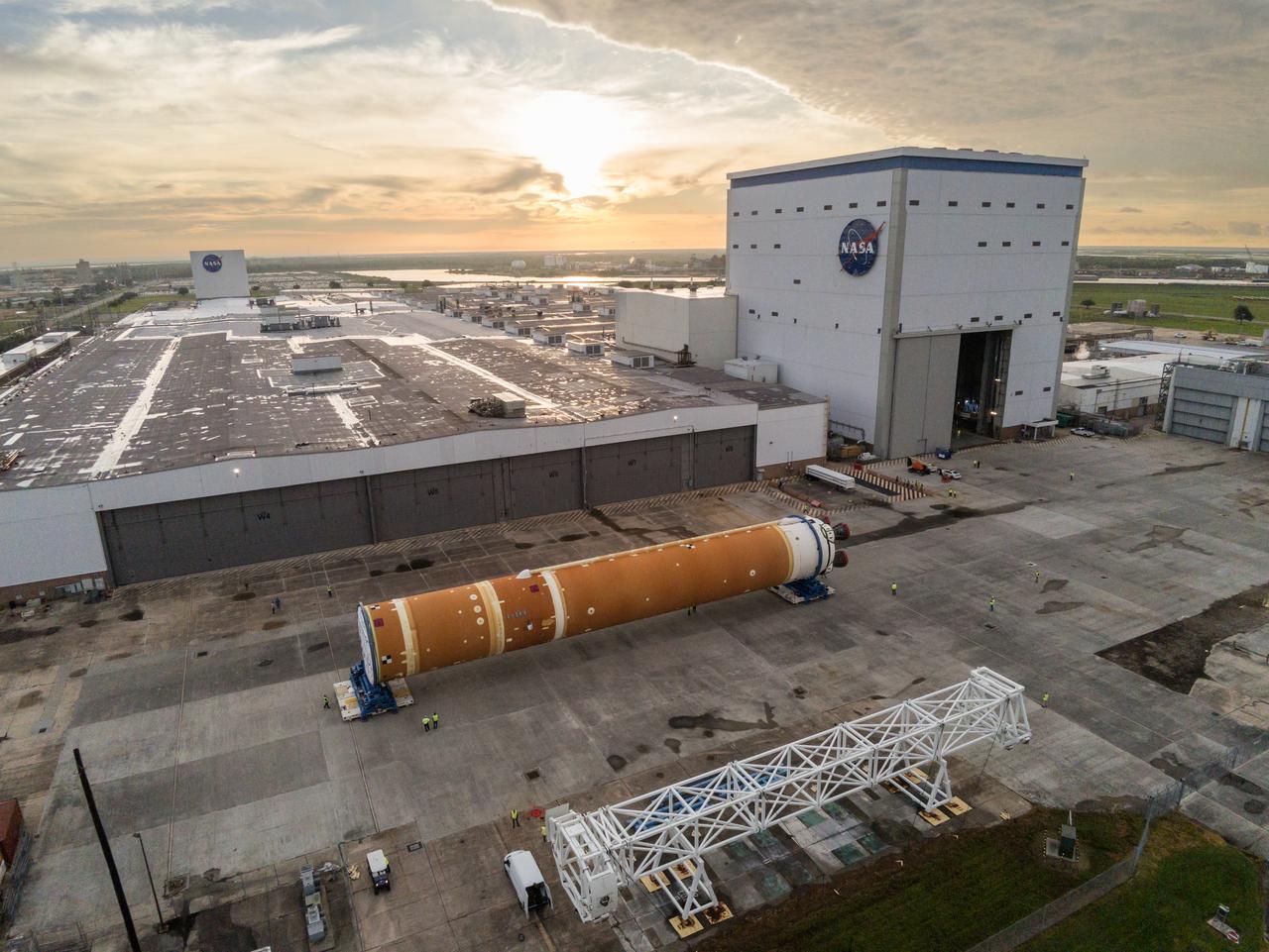 This photo shows NASA and Boeing, the SLS core stage lead contractor, preparing the SLS (Space Launch System) rocket core stage for shipment at NASA’s Michoud Assembly Facility in New Orleans. On July 6, NASA and Boeing moved the Artemis II rocket stage to Building 110. The move comes as teams prepare to roll the massive rocket stage with its four RS-25 engines to the agency’s Pegasus barge for delivery to NASA’s Kennedy Space Center in Florida in mid-July. Prior to the move, technicians began removing external access stands, or scaffolding, surrounding the core stage to assess the interior elements, including its complex avionics and flight propulsion systems. The stage is fully manufactured at NASA Michoud.  NASA is working to land the first woman, first person of color, and its first international partner astronaut on the Moon under Artemis. SLS is part of NASA’s backbone for deep space exploration, along with the Orion spacecraft, supporting ground systems, advanced spacesuits and rovers, the Gateway in orbit around the Moon, and commercial human landing systems. SLS is the only rocket that can send Orion, astronauts, and supplies to the Moon in a single launch.