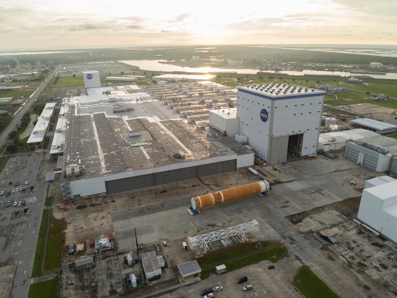 This photo shows NASA and Boeing, the SLS core stage lead contractor, preparing the SLS (Space Launch System) rocket core stage for shipment at NASA’s Michoud Assembly Facility in New Orleans. On July 6, NASA and Boeing moved the Artemis II rocket stage to Building 110. The move comes as teams prepare to roll the massive rocket stage with its four RS-25 engines to the agency’s Pegasus barge for delivery to NASA’s Kennedy Space Center in Florida in mid-July. Prior to the move, technicians began removing external access stands, or scaffolding, surrounding the core stage to assess the interior elements, including its complex avionics and flight propulsion systems. The stage is fully manufactured at NASA Michoud.  NASA is working to land the first woman, first person of color, and its first international partner astronaut on the Moon under Artemis. SLS is part of NASA’s backbone for deep space exploration, along with the Orion spacecraft, supporting ground systems, advanced spacesuits and rovers, the Gateway in orbit around the Moon, and commercial human landing systems. SLS is the only rocket that can send Orion, astronauts, and supplies to the Moon in a single launch.