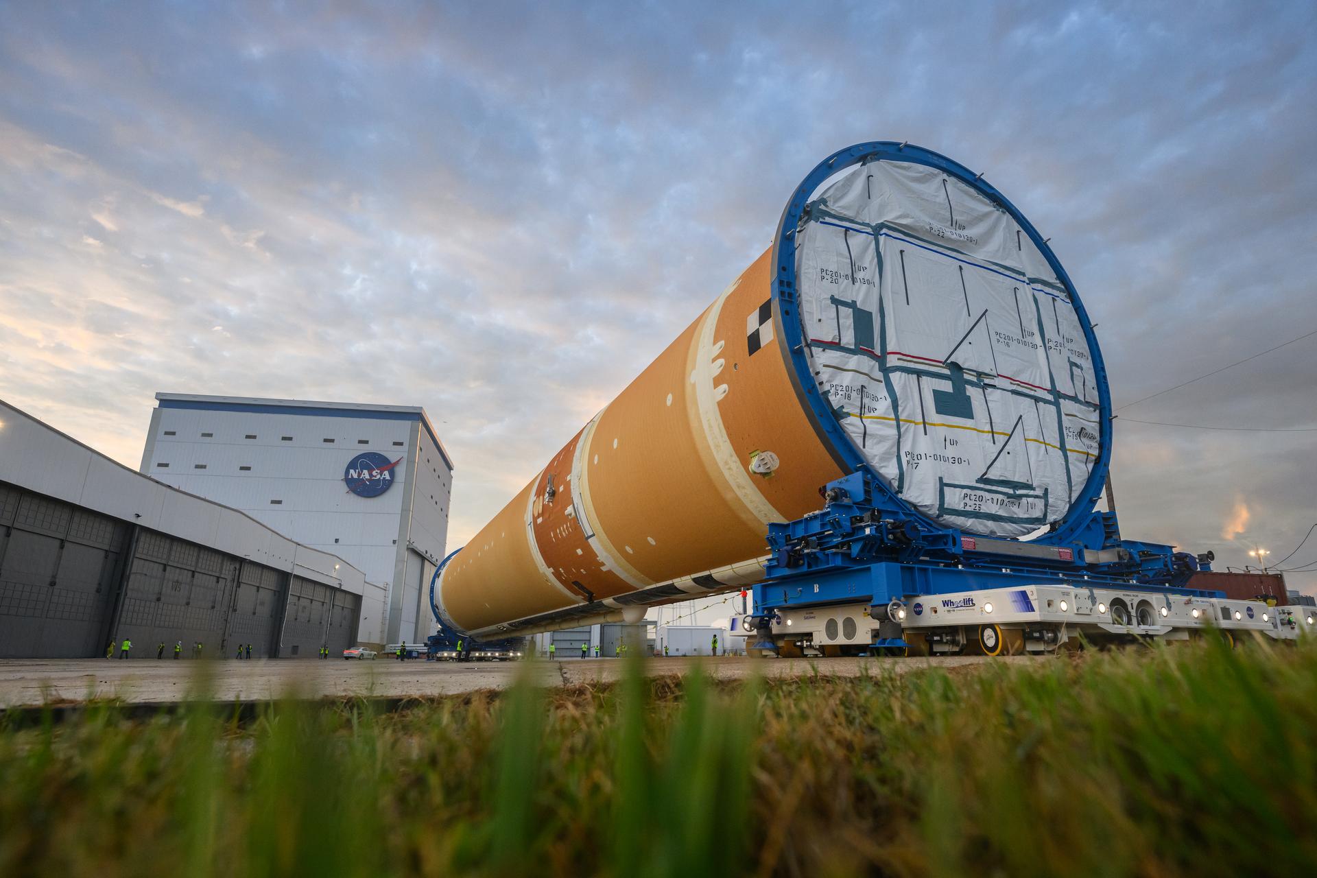 This photo shows NASA and Boeing, the SLS core stage lead contractor, preparing the SLS (Space Launch System) rocket core stage for shipment at NASA’s Michoud Assembly Facility in New Orleans. On July 6, NASA and Boeing moved the Artemis II rocket stage to Building 110. The move comes as teams prepare to roll the massive rocket stage with its four RS-25 engines to the agency’s Pegasus barge for delivery to NASA’s Kennedy Space Center in Florida in mid-July. Prior to the move, technicians began removing external access stands, or scaffolding, surrounding the core stage to assess the interior elements, including its complex avionics and flight propulsion systems. The stage is fully manufactured at NASA Michoud. NASA is working to land the first woman, first person of color, and its first international partner astronaut on the Moon under Artemis. SLS is part of NASA’s backbone for deep space exploration, along with the Orion spacecraft, supporting ground systems, advanced spacesuits and rovers, the Gateway in orbit around the Moon, and commercial human landing systems. SLS is the only rocket that can send Orion, astronauts, and supplies to the Moon in a single launch.