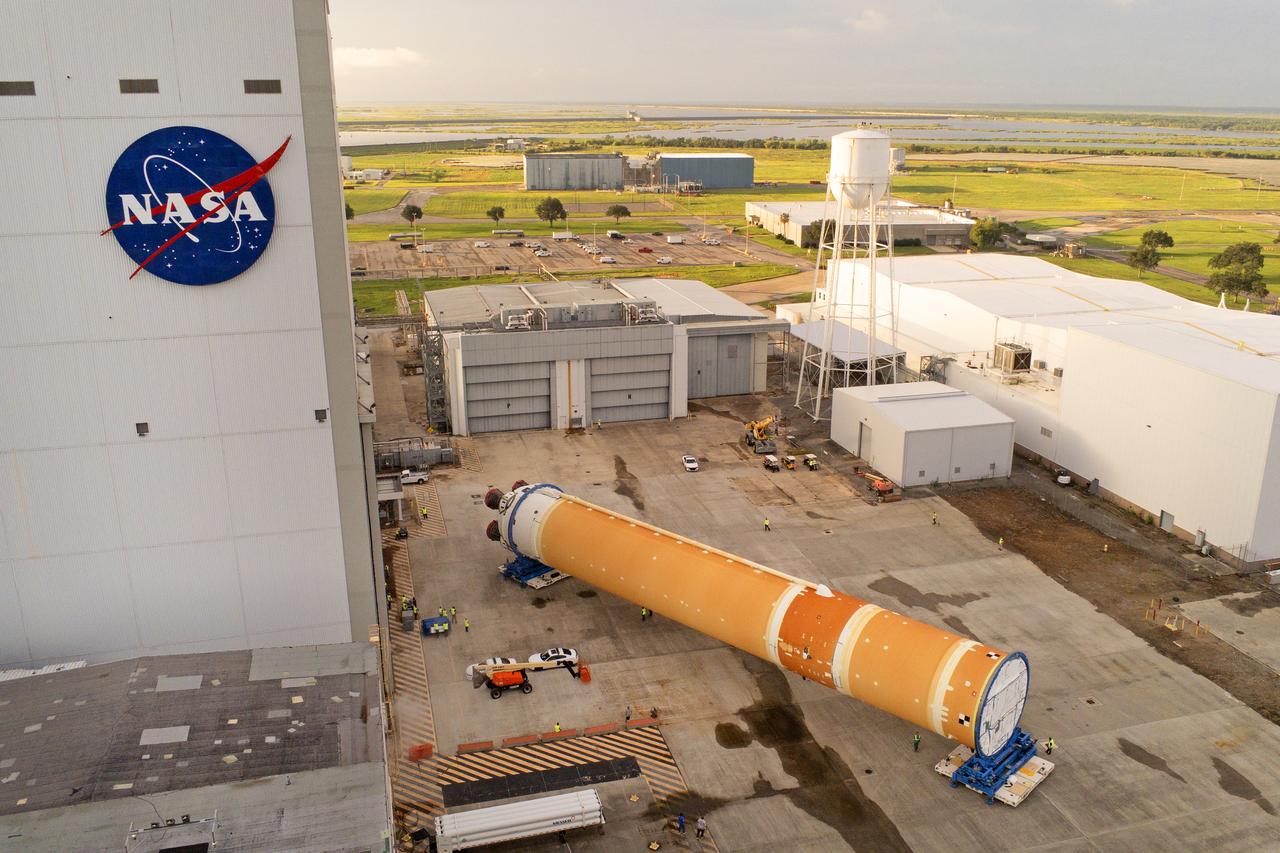 This photo shows NASA and Boeing, the SLS core stage lead contractor, preparing the SLS (Space Launch System) rocket core stage for shipment at NASA’s Michoud Assembly Facility in New Orleans. On July 6, NASA and Boeing moved the Artemis II rocket stage to Building 110. The move comes as teams prepare to roll the massive rocket stage with its four RS-25 engines to the agency’s Pegasus barge for delivery to NASA’s Kennedy Space Center in Florida in mid-July. Prior to the move, technicians began removing external access stands, or scaffolding, surrounding the core stage to assess the interior elements, including its complex avionics and flight propulsion systems. The stage is fully manufactured at NASA Michoud.  NASA is working to land the first woman, first person of color, and its first international partner astronaut on the Moon under Artemis. SLS is part of NASA’s backbone for deep space exploration, along with the Orion spacecraft, supporting ground systems, advanced spacesuits and rovers, the Gateway in orbit around the Moon, and commercial human landing systems. SLS is the only rocket that can send Orion, astronauts, and supplies to the Moon in a single launch.  Image credit: NASA/Michael DeMocker