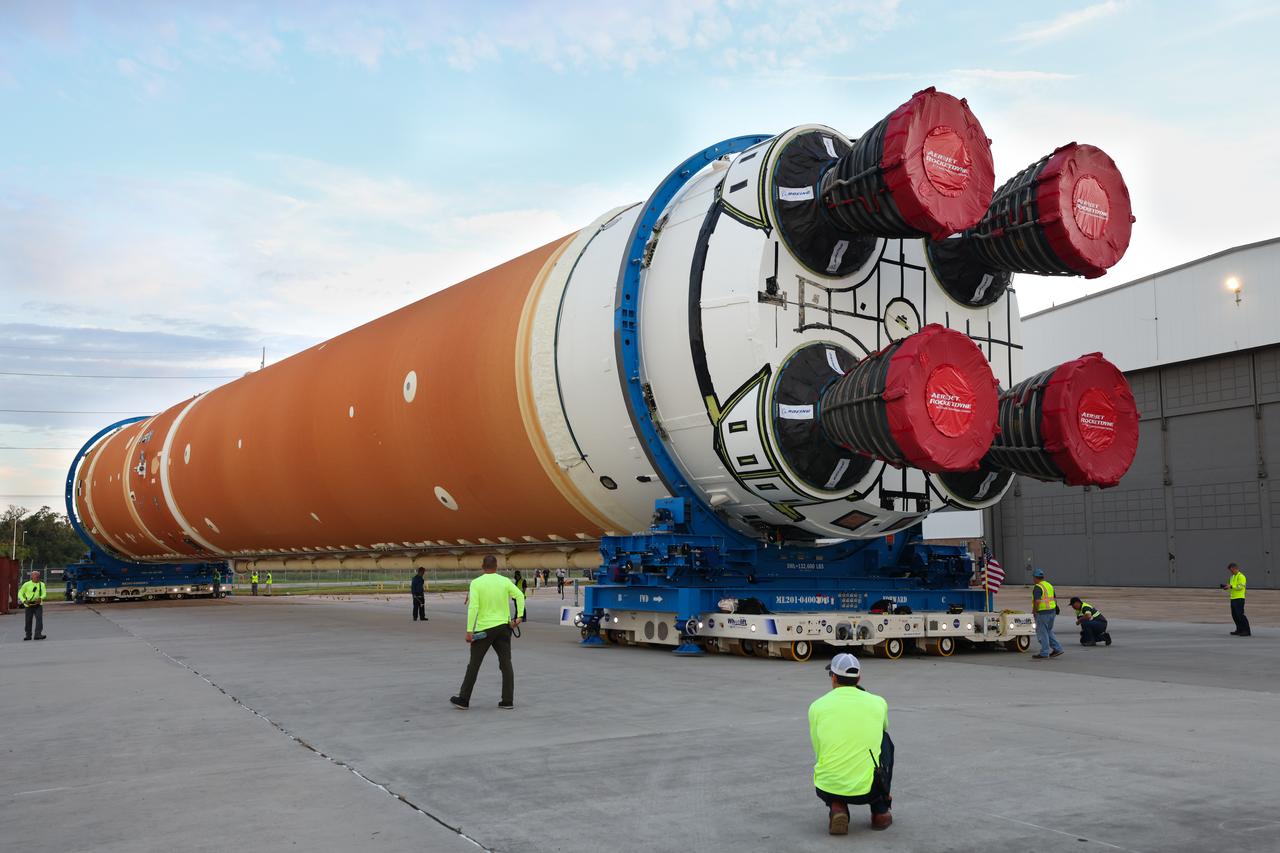 This photo shows NASA and Boeing, the SLS core stage lead contractor, preparing the SLS (Space Launch System) rocket core stage for shipment at NASA’s Michoud Assembly Facility in New Orleans. On July 6, NASA and Boeing moved the Artemis II rocket stage to Building 110. The move comes as teams prepare to roll the massive rocket stage with its four RS-25 engines to the agency’s Pegasus barge for delivery to NASA’s Kennedy Space Center in Florida in mid-July. Prior to the move, technicians began removing external access stands, or scaffolding, surrounding the core stage to assess the interior elements, including its complex avionics and flight propulsion systems. The stage is fully manufactured at NASA Michoud.  NASA is working to land the first woman, first person of color, and its first international partner astronaut on the Moon under Artemis. SLS is part of NASA’s backbone for deep space exploration, along with the Orion spacecraft, supporting ground systems, advanced spacesuits and rovers, the Gateway in orbit around the Moon, and commercial human landing systems. SLS is the only rocket that can send Orion, astronauts, and supplies to the Moon in a single launch.