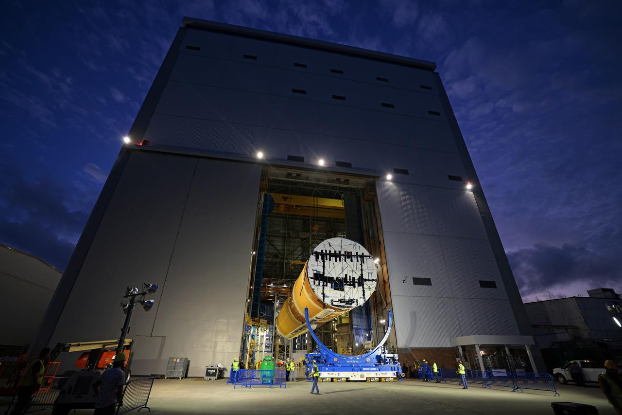 Technicians at Michoud Assembly Facility in New Orleans lift the core stage that will help launch the first crewed flight of NASA’s SLS (Space Launch System) rocket for the agency’s Artemis II mission. Teams at Michoud lifted the core stage on Thursday, July 11, 2024, onto NASA’s Multi-Purpose Transportation System, designed to transport SLS vehicle segments by waterway and roadway. It is tasked with transporting the vehicle from where it is manufactured to its intermediate test location and final launch destination. The core stage was lifted in preparation for its move onto the agency’s Pegasus barge, where it will be ferried to NASA’s Kennedy Space Center in Florida. Pegasus is maintained at Michoud. The core stage for the SLS mega rocket is the largest stage NASA has ever produced. At 212 feet tall, the stage consists of five major elements, including two huge propellant tanks that collectively hold more than 733,000 gallons of super chilled liquid propellant to feed four RS-25 engines at its base. During launch and flight, the stage will operate for just over eight minutes, producing more than 2 million pounds of thrust to help send a crew of four astronauts inside NASA’s Orion spacecraft onward to the Moon. All the major structures for every SLS core stage are fully manufactured at NASA Michoud.  NASA is working to land the first woman, first person of color, and its first international partner astronaut on the Moon under Artemis. SLS is part of NASA’s backbone for deep space exploration, along with the Orion spacecraft and Gateway in orbit around the Moon and commercial human landing systems, next-generation space, next-generational spacesuits, and rovers on the lunar surface. SLS is the only rocket that can send Orion, astronauts, and supplies to the Moon in a single launch. Image credit: NASA/Michael DeMocker