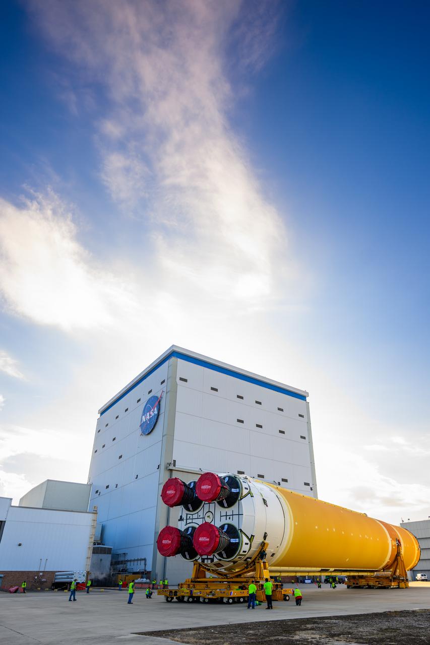 This photo shows NASA and Boeing, the SLS core stage lead contractor, preparing the SLS (Space Launch System) rocket core stage for shipment at NASA’s Michoud Assembly Facility in New Orleans. On July 6, NASA and Boeing moved the Artemis II rocket stage to Building 110. The move comes as teams prepare to roll the massive rocket stage with its four RS-25 engines to the agency’s Pegasus barge for delivery to NASA’s Kennedy Space Center in Florida in mid-July. Prior to the move, technicians began removing external access stands, or scaffolding, surrounding the core stage to assess the interior elements, including its complex avionics and flight propulsion systems. The stage is fully manufactured at NASA Michoud.