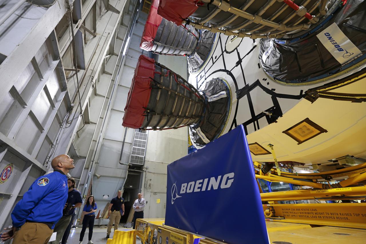 NASA astronaut Victor Glover views the core stage of the SLS (Space Launch System) rocket that will help power Artemis II at NASA’s Michoud Assembly Facility in New Orleans July 15. Glover will pilot Artemis II, the first crewed mission of NASA’s Artemis campaign. Crews moved the 212-foot-tall core stage with its four RS-25 engines to Building 110 at NASA Michoud prior to rolling it out to NASA’s Pegasus barge July 16 for delivery to NASA’s Kennedy Space Center in Florida. The core stage has two giant propellant tanks that collectively hold more than 733,000 gallons of super cold liquid propellant to feed the stage’s four RS-25 engines. Together, the engines produce more than 2 million pounds of thrust to help send astronauts inside NASA’s Orion spacecraft to venture around the Moon for Artemis II.  NASA is working to land the first woman, first person of color, and its first international partner astronaut on the Moon under Artemis. SLS is part of NASA’s backbone for deep space exploration, along with the Orion spacecraft, supporting ground systems, advanced spacesuits and rovers, the Gateway in orbit around the Moon, and commercial human landing systems. SLS is the only rocket that can send Orion, astronauts, and supplies to the Moon in a single launch.  