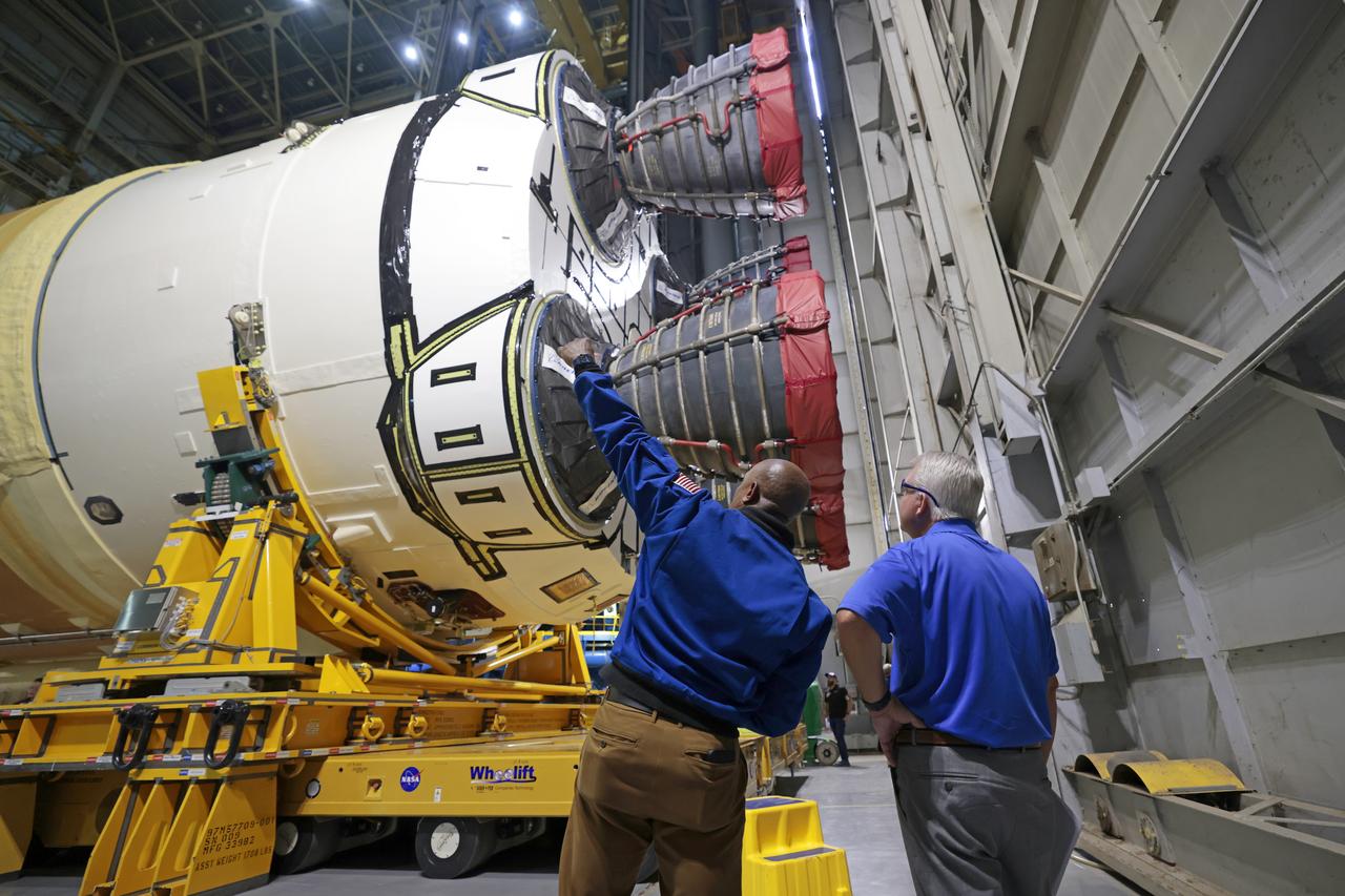 NASA astronaut Victor Glover views the core stage of the SLS (Space Launch System) rocket that will help power Artemis II at NASA’s Michoud Assembly Facility in New Orleans July 15. Glover will pilot Artemis II, the first crewed mission of NASA’s Artemis campaign. Crews moved the 212-foot-tall core stage with its four RS-25 engines to Building 110 at NASA Michoud prior to rolling it out to NASA’s Pegasus barge July 16 for delivery to NASA’s Kennedy Space Center in Florida. The core stage has two giant propellant tanks that collectively hold more than 733,000 gallons of super cold liquid propellant to feed the stage’s four RS-25 engines. Together, the engines produce more than 2 million pounds of thrust to help send astronauts inside NASA’s Orion spacecraft to venture around the Moon for Artemis II.  NASA is working to land the first woman, first person of color, and its first international partner astronaut on the Moon under Artemis. SLS is part of NASA’s backbone for deep space exploration, along with the Orion spacecraft, supporting ground systems, advanced spacesuits and rovers, the Gateway in orbit around the Moon, and commercial human landing systems. SLS is the only rocket that can send Orion, astronauts, and supplies to the Moon in a single launch.  