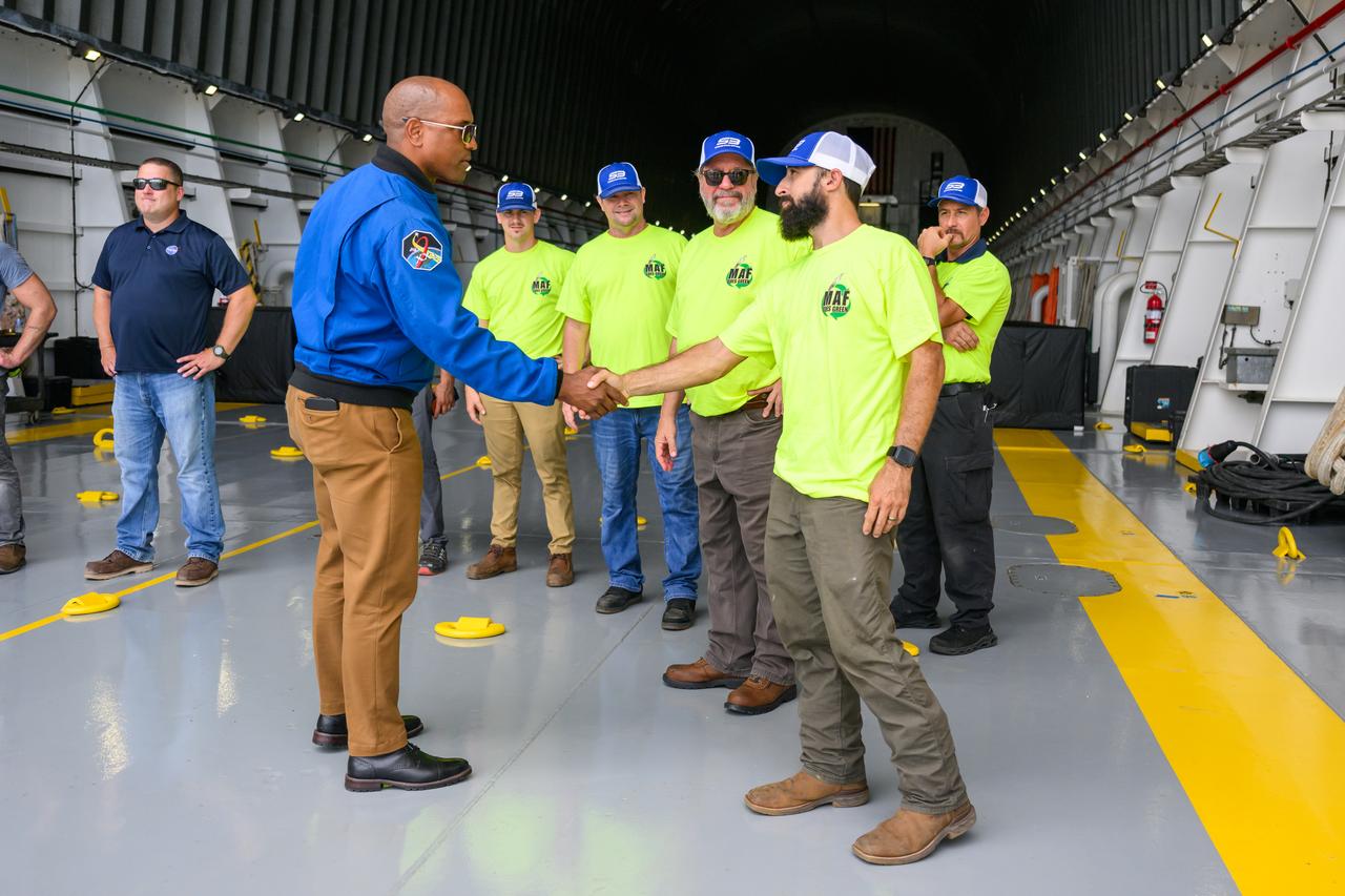 NASA astronaut Victor Glover views the core stage of the SLS (Space Launch System) rocket that will help power Artemis II at NASA’s Michoud Assembly Facility in New Orleans July 15. Glover will pilot Artemis II, the first crewed mission of NASA’s Artemis campaign. Crews moved the 212-foot-tall core stage with its four RS-25 engines to Building 110 at NASA Michoud prior to rolling it out to NASA’s Pegasus barge July 16 for delivery to NASA’s Kennedy Space Center in Florida. The core stage has two giant propellant tanks that collectively hold more than 733,000 gallons of super cold liquid propellant to feed the stage’s four RS-25 engines. Together, the engines produce more than 2 million pounds of thrust to help send astronauts inside NASA’s Orion spacecraft to venture around the Moon for Artemis II.  NASA is working to land the first woman, first person of color, and its first international partner astronaut on the Moon under Artemis. SLS is part of NASA’s backbone for deep space exploration, along with the Orion spacecraft, supporting ground systems, advanced spacesuits and rovers, the Gateway in orbit around the Moon, and commercial human landing systems. SLS is the only rocket that can send Orion, astronauts, and supplies to the Moon in a single launch.  