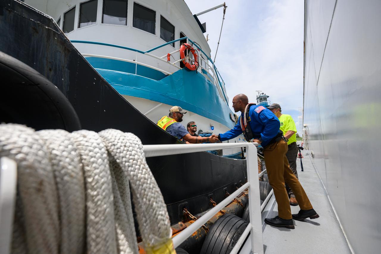 NASA astronaut Victor Glover views the core stage of the SLS (Space Launch System) rocket that will help power Artemis II at NASA’s Michoud Assembly Facility in New Orleans July 15. Glover will pilot Artemis II, the first crewed mission of NASA’s Artemis campaign. Crews moved the 212-foot-tall core stage with its four RS-25 engines to Building 110 at NASA Michoud prior to rolling it out to NASA’s Pegasus barge July 16 for delivery to NASA’s Kennedy Space Center in Florida. The core stage has two giant propellant tanks that collectively hold more than 733,000 gallons of super cold liquid propellant to feed the stage’s four RS-25 engines. Together, the engines produce more than 2 million pounds of thrust to help send astronauts inside NASA’s Orion spacecraft to venture around the Moon for Artemis II.  NASA is working to land the first woman, first person of color, and its first international partner astronaut on the Moon under Artemis. SLS is part of NASA’s backbone for deep space exploration, along with the Orion spacecraft, supporting ground systems, advanced spacesuits and rovers, the Gateway in orbit around the Moon, and commercial human landing systems. SLS is the only rocket that can send Orion, astronauts, and supplies to the Moon in a single launch.  