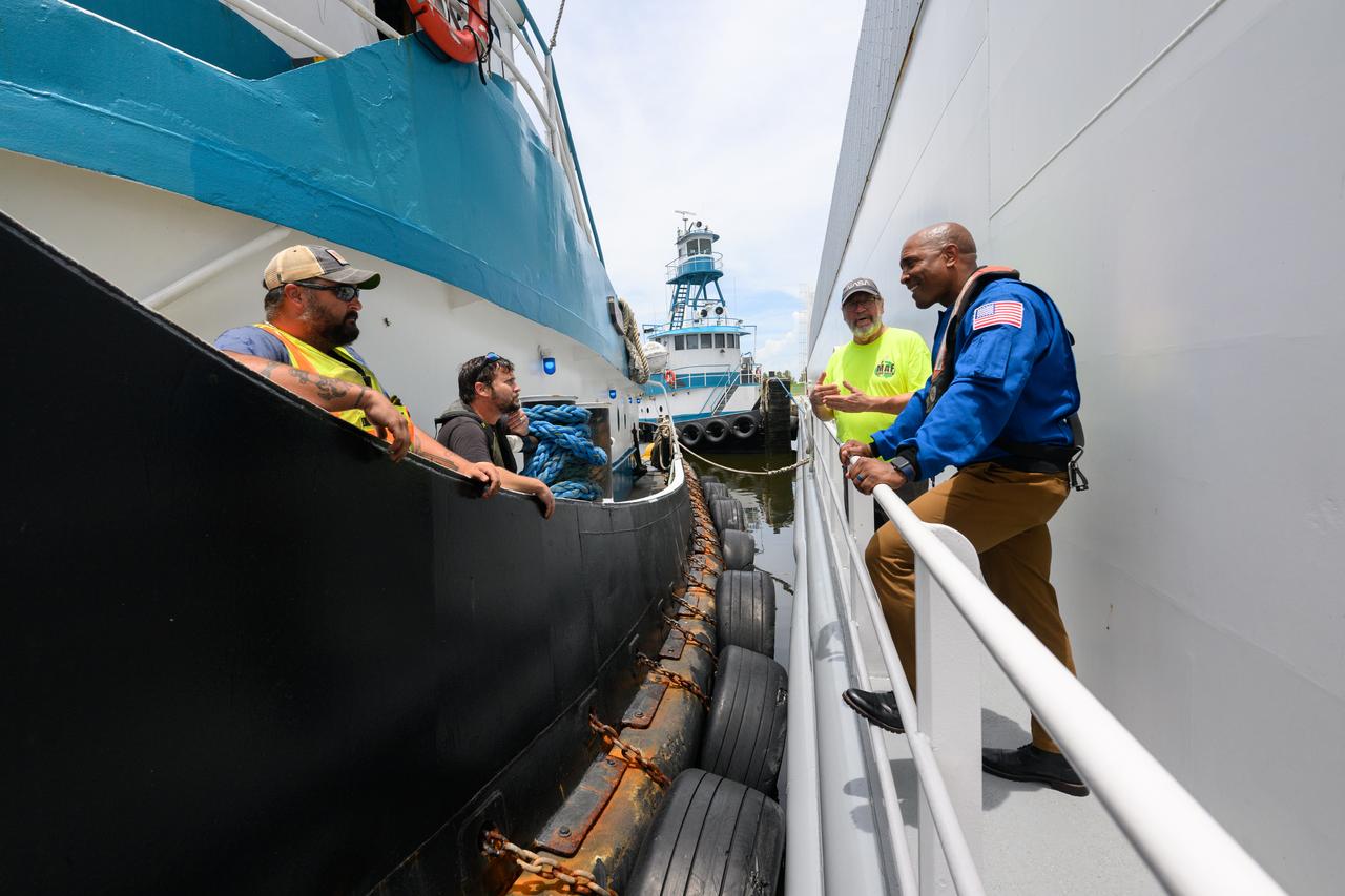 NASA astronaut Victor Glover views the core stage of the SLS (Space Launch System) rocket that will help power Artemis II at NASA’s Michoud Assembly Facility in New Orleans July 15. Glover will pilot Artemis II, the first crewed mission of NASA’s Artemis campaign. Crews moved the 212-foot-tall core stage with its four RS-25 engines to Building 110 at NASA Michoud prior to rolling it out to NASA’s Pegasus barge July 16 for delivery to NASA’s Kennedy Space Center in Florida. The core stage has two giant propellant tanks that collectively hold more than 733,000 gallons of super cold liquid propellant to feed the stage’s four RS-25 engines. Together, the engines produce more than 2 million pounds of thrust to help send astronauts inside NASA’s Orion spacecraft to venture around the Moon for Artemis II.  NASA is working to land the first woman, first person of color, and its first international partner astronaut on the Moon under Artemis. SLS is part of NASA’s backbone for deep space exploration, along with the Orion spacecraft, supporting ground systems, advanced spacesuits and rovers, the Gateway in orbit around the Moon, and commercial human landing systems. SLS is the only rocket that can send Orion, astronauts, and supplies to the Moon in a single launch.  