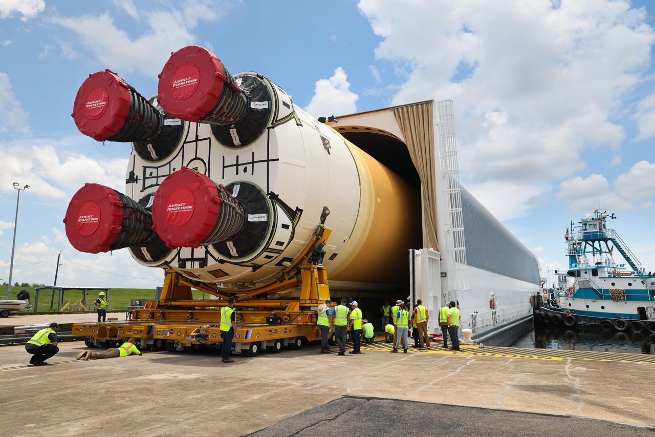 These images and videos show team members at Michoud Assembly Facility loading the first core stage that will help launch the first crewed flight of NASA’s SLS (Space Launch System) rocket for the agency’s Artemis II mission onto the Pegasus barge on Tuesday, July 16, 2024. The barge will ferry the core stage on a 900-mile journey from the agency’s Michoud Assembly Facility in New Orleans to its Kennedy Space Center in Florida. The core stage for the SLS mega rocket is the largest stage NASA has ever produced. At 212 feet tall, the stage consists of five major elements, including two huge propellant tanks that collectively hold more than 733,000 gallons of super chilled liquid propellant to feed four RS-25 engines at its base. During launch and flight, the stage will operate for just over eight minutes, producing more than 2 million pounds of thrust to help send a crew of four astronauts inside NASA’s Orion spacecraft onward to the Moon. All the major structures for every SLS core stage are fully manufactured at NASA Michoud.  NASA is working to land the first woman, first person of color, and its first international partner astronaut on the Moon under Artemis. SLS is part of NASA’s backbone for deep space exploration, along with the Orion spacecraft and Gateway in orbit around the Moon and commercial human landing systems, next-generation space, next-generational spacesuits, and rovers on the lunar surface. SLS is the only rocket that can send Orion, astronauts, and supplies to the Moon in a single launch. 