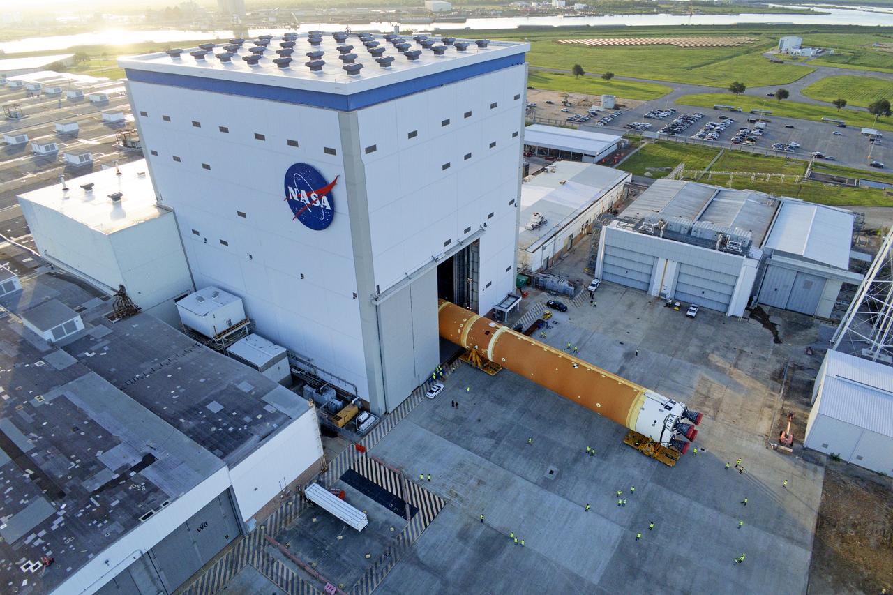 These images and videos show team members moving the first core stage that will help launch the first crewed flight of NASA’s SLS (Space Launch System) rocket for the agency’s Artemis II mission. The move marked the first time a fully assembled Moon rocket stage for a crewed mission has rolled out from NASA’s Michoud Assembly Facility in New Orleans since the Apollo Program, The core stage was moved onto the agency’s Pegasus barge, where it will be ferried to NASA’s Kennedy Space Center in Florida.  The core stage for the SLS mega rocket is the largest stage NASA has ever produced. At 212 feet tall, the stage consists of five major elements, including two huge propellant tanks that collectively hold more than 733,000 gallons of super chilled liquid propellant to feed four RS-25 engines at its base. During launch and flight, the stage will operate for just over eight minutes, producing more than 2 million pounds of thrust to help send a crew of four astronauts inside NASA’s Orion spacecraft onward to the Moon.  NASA is working to land the first woman, first person of color, and its first international partner astronaut on the Moon under Artemis. SLS is part of NASA’s backbone for deep space exploration, along with the Orion spacecraft and Gateway in orbit around the Moon and commercial human landing systems, next-generation space, next-generational spacesuits, and rovers on the lunar surface. SLS is the only rocket that can send Orion, astronauts, and supplies to the Moon in a single launch. 