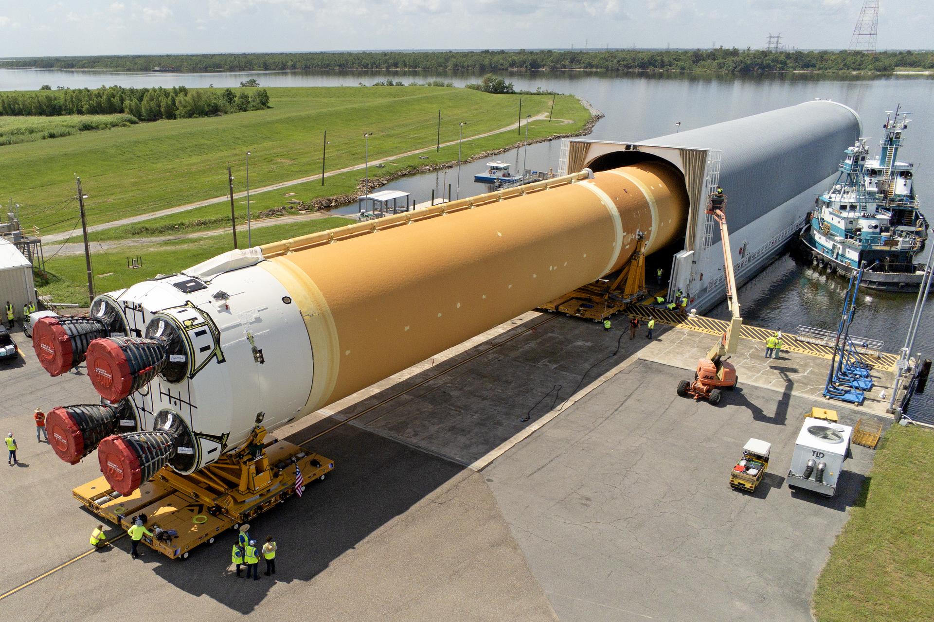 These images and videos show team members at Michoud Assembly Facility loading the first core stage that will help launch the first crewed flight of NASA’s SLS (Space Launch System) rocket for the agency’s Artemis II mission onto the Pegasus barge on Tuesday, July 16, 2024. The barge will ferry the core stage on a 900-mile journey from the agency’s Michoud Assembly Facility in New Orleans to its Kennedy Space Center in Florida. The core stage for the SLS mega rocket is the largest stage NASA has ever produced. At 212 feet tall, the stage consists of five major elements, including two huge propellant tanks that collectively hold more than 733,000 gallons of super chilled liquid propellant to feed four RS-25 engines at its base. During launch and flight, the stage will operate for just over eight minutes, producing more than 2 million pounds of thrust to help send a crew of four astronauts inside NASA’s Orion spacecraft onward to the Moon. All the major structures for every SLS core stage are fully manufactured at NASA Michoud. NASA is working to land the first woman, first person of color, and its first international partner astronaut on the Moon under Artemis. SLS is part of NASA’s backbone for deep space exploration, along with the Orion spacecraft and Gateway in orbit around the Moon and commercial human landing systems, next-generation space, next-generational spacesuits, and rovers on the lunar surface. SLS is the only rocket that can send Orion, astronauts, and supplies to the Moon in a single launch.